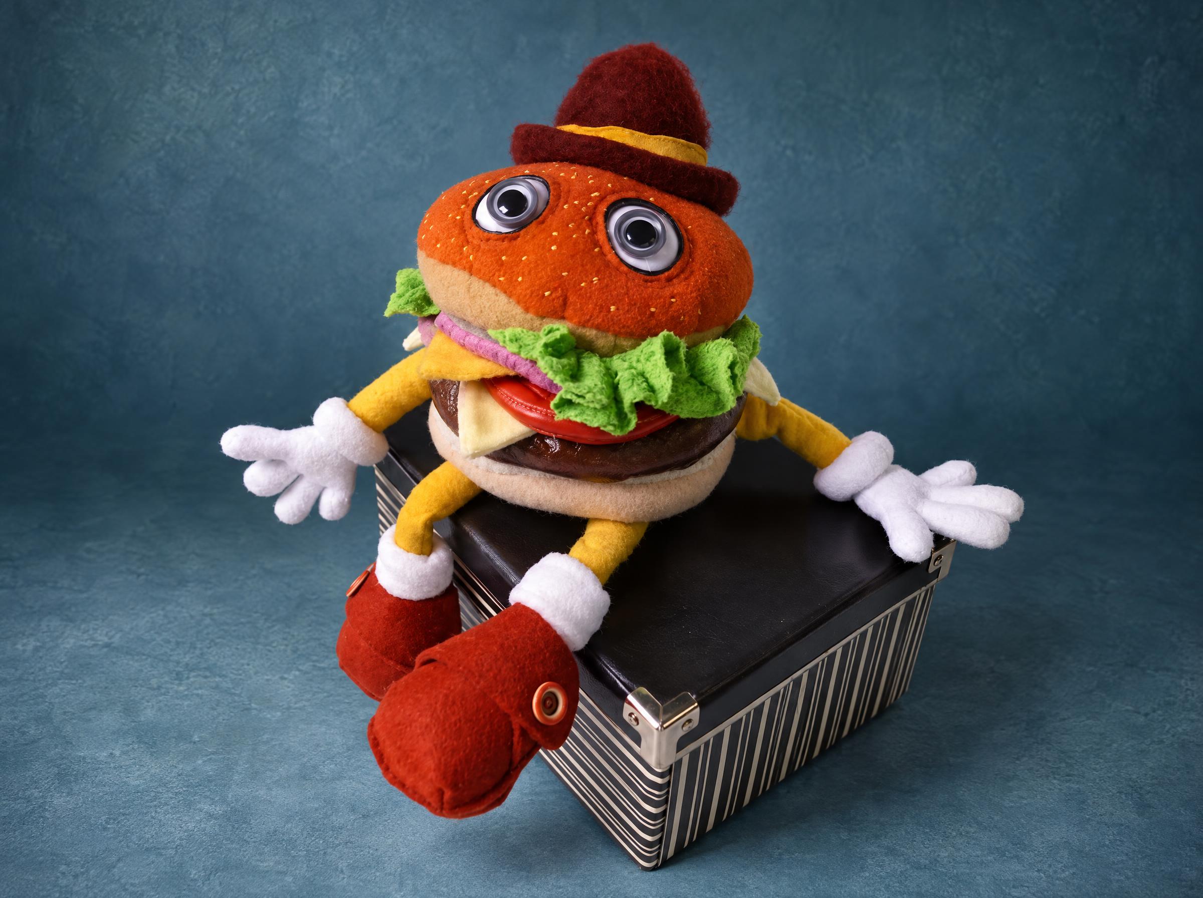 Hamburger plush toy in a felt hat Food plush toy made to order: a hamburger man in a maroon hat with googly eyes, yellow arms and white gloves