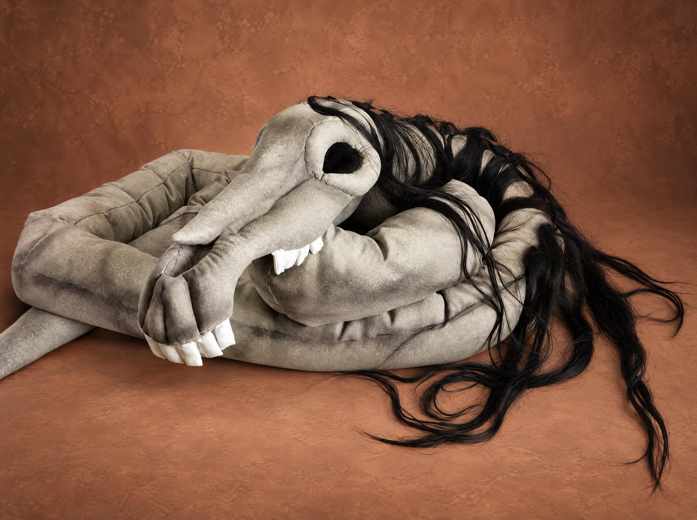 Handmade Long Horse Toy with a Coiled Neck Handmade Long Horse toy, sewn to order: grey skull with white teeth on a long coiled neck, black hair trailing