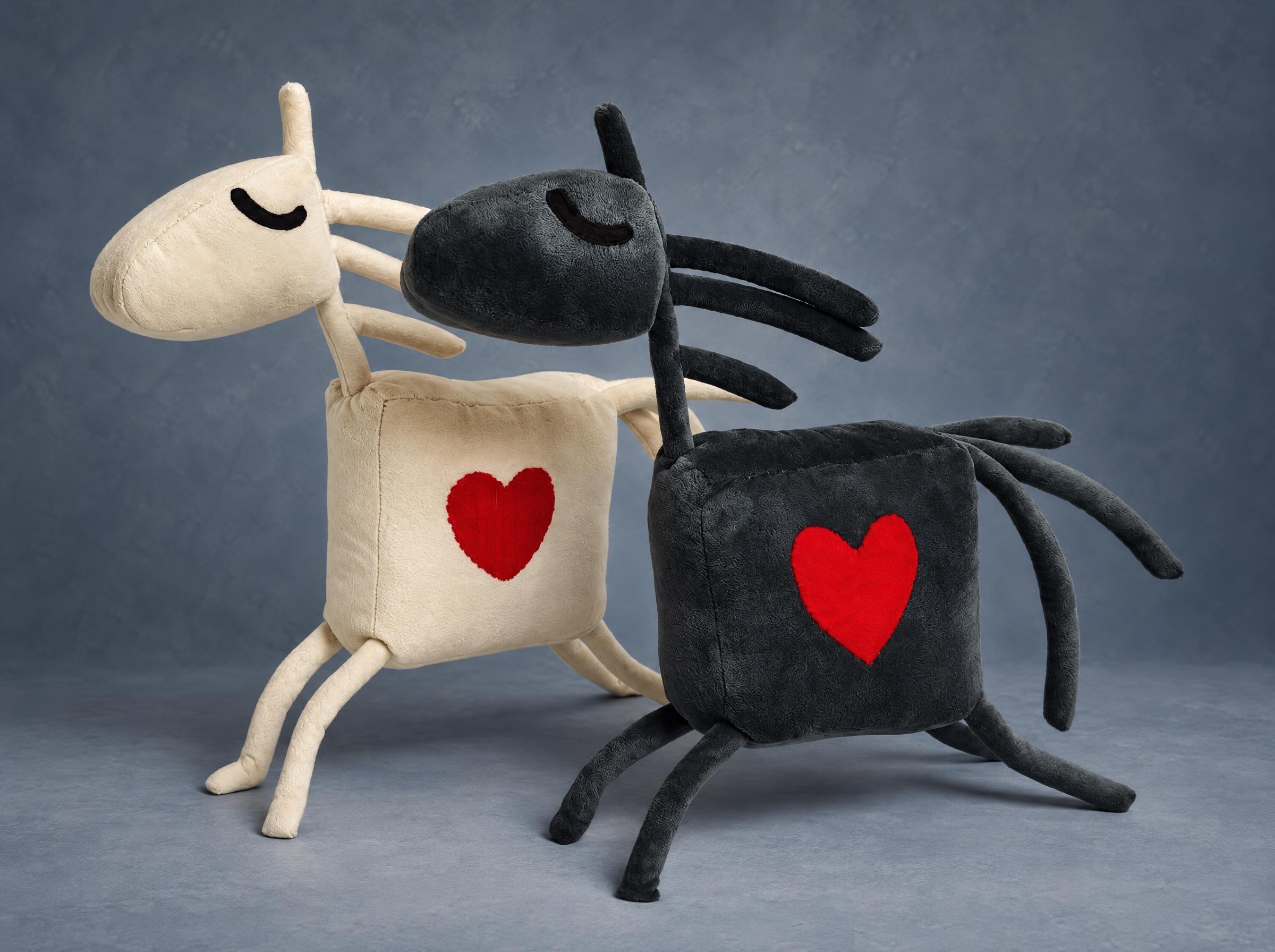 Two horse mascot plushes, cream and charcoal grey, each with a red heart, sewn to order for a riding club
