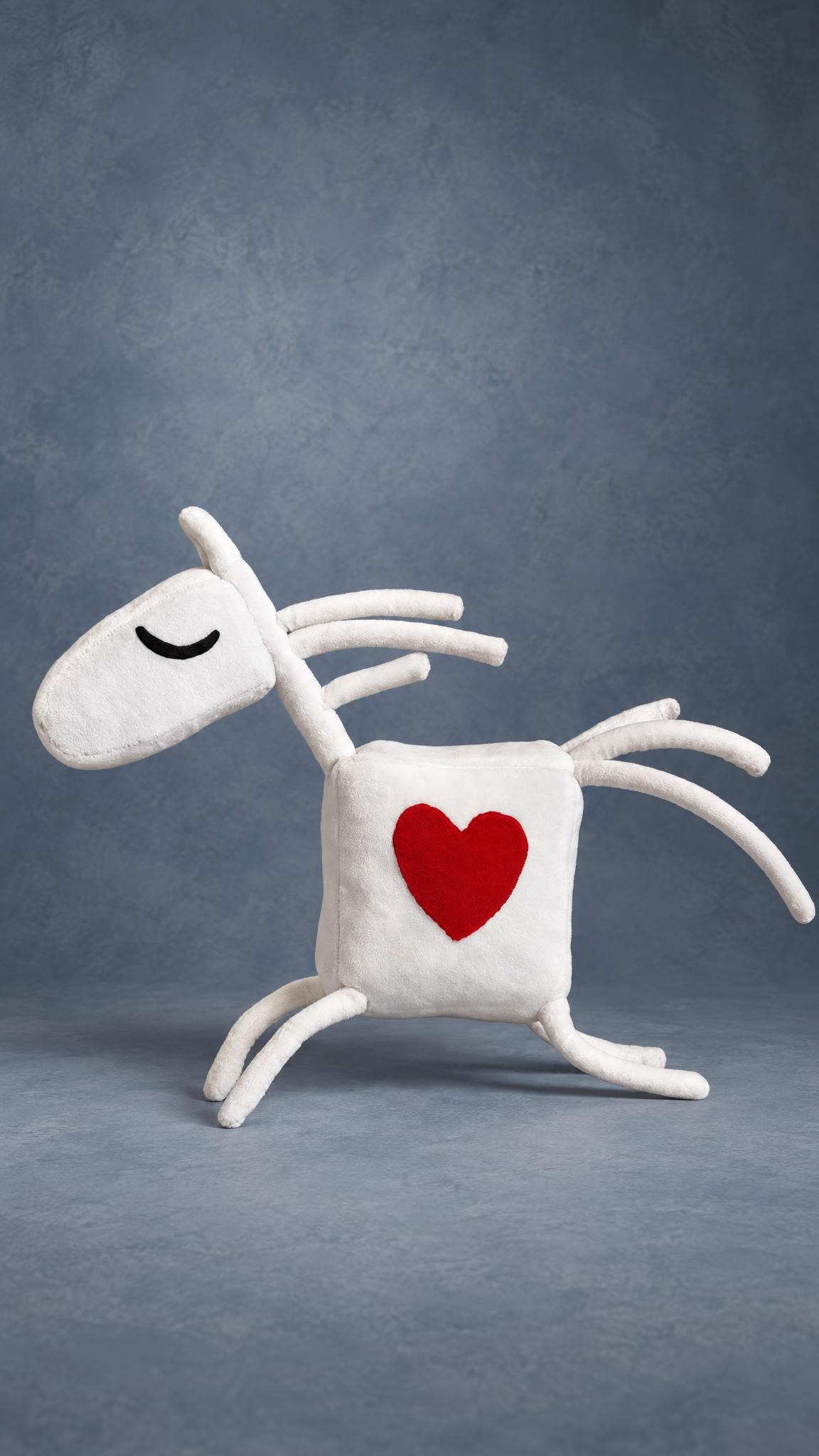 White horse mascot plush with a red heart and sleepy closed eyes, custom made for a kids' riding club