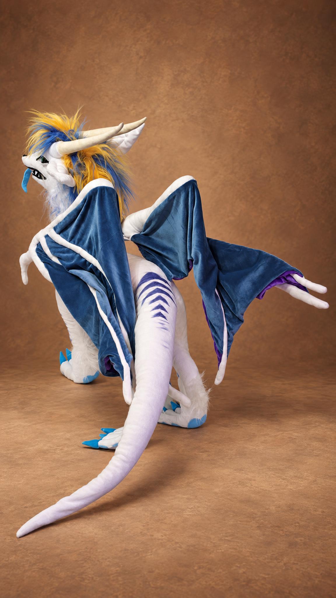 Ice dragon plush made to order, steel-blue wings from behind and a long white tail with navy spine stripes