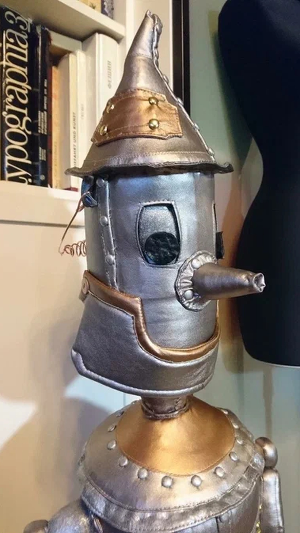 Iron Woodcutter doll face with a funnel hat, round eyes and a long nose, a custom Tin Man doll sewn to order