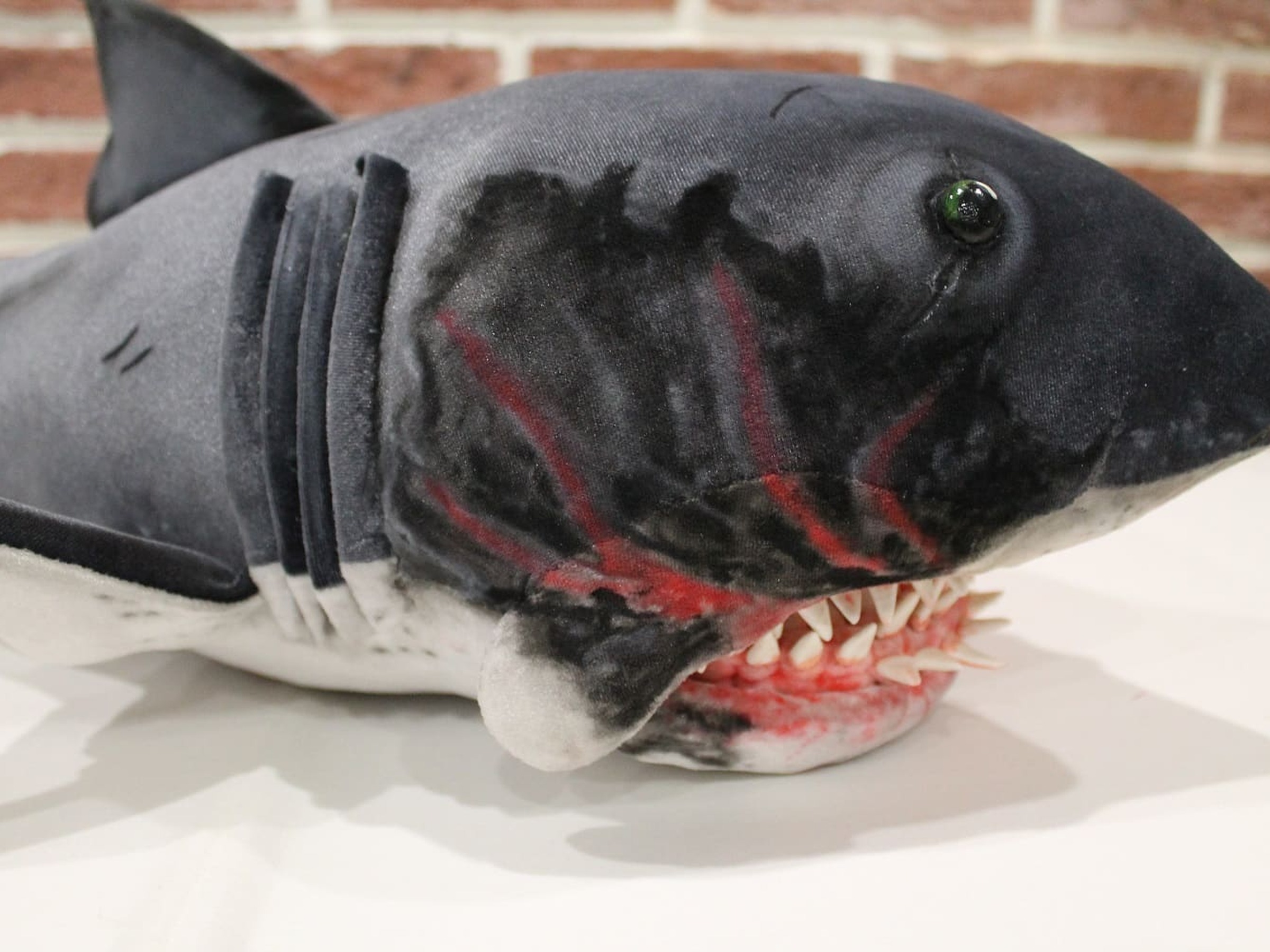 Jaws-inspired shark plush, scars and gills Jaws-inspired shark plush with sewn gill slits, red painted scars and a glass eye, a custom horror plush made to order