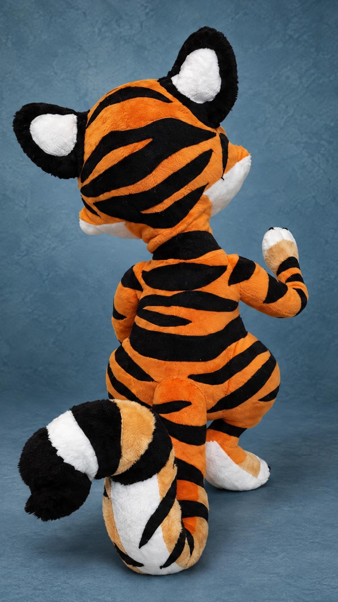 Handmade tiger cub plush with black stripes and a black-and-white striped tail, made to order from a sticker