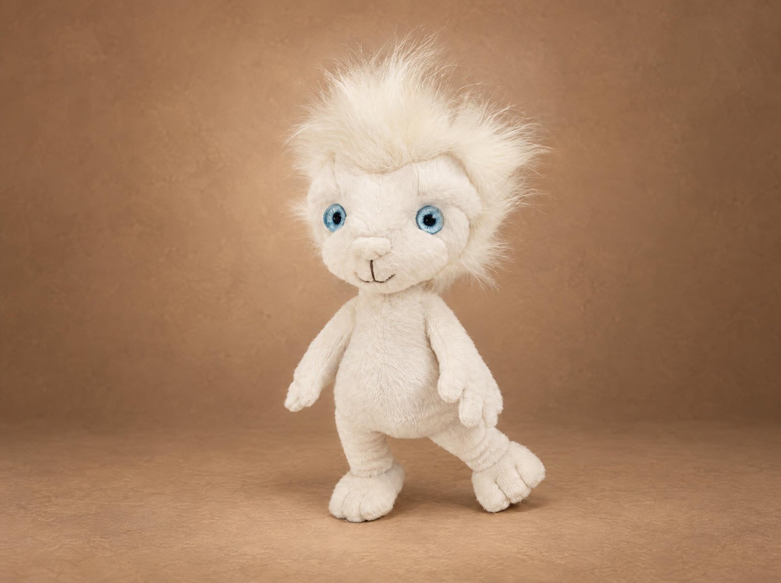 Custom lion plush prototype sewn by hand for a writer's character, spiky white long-pile mane, blue eyes