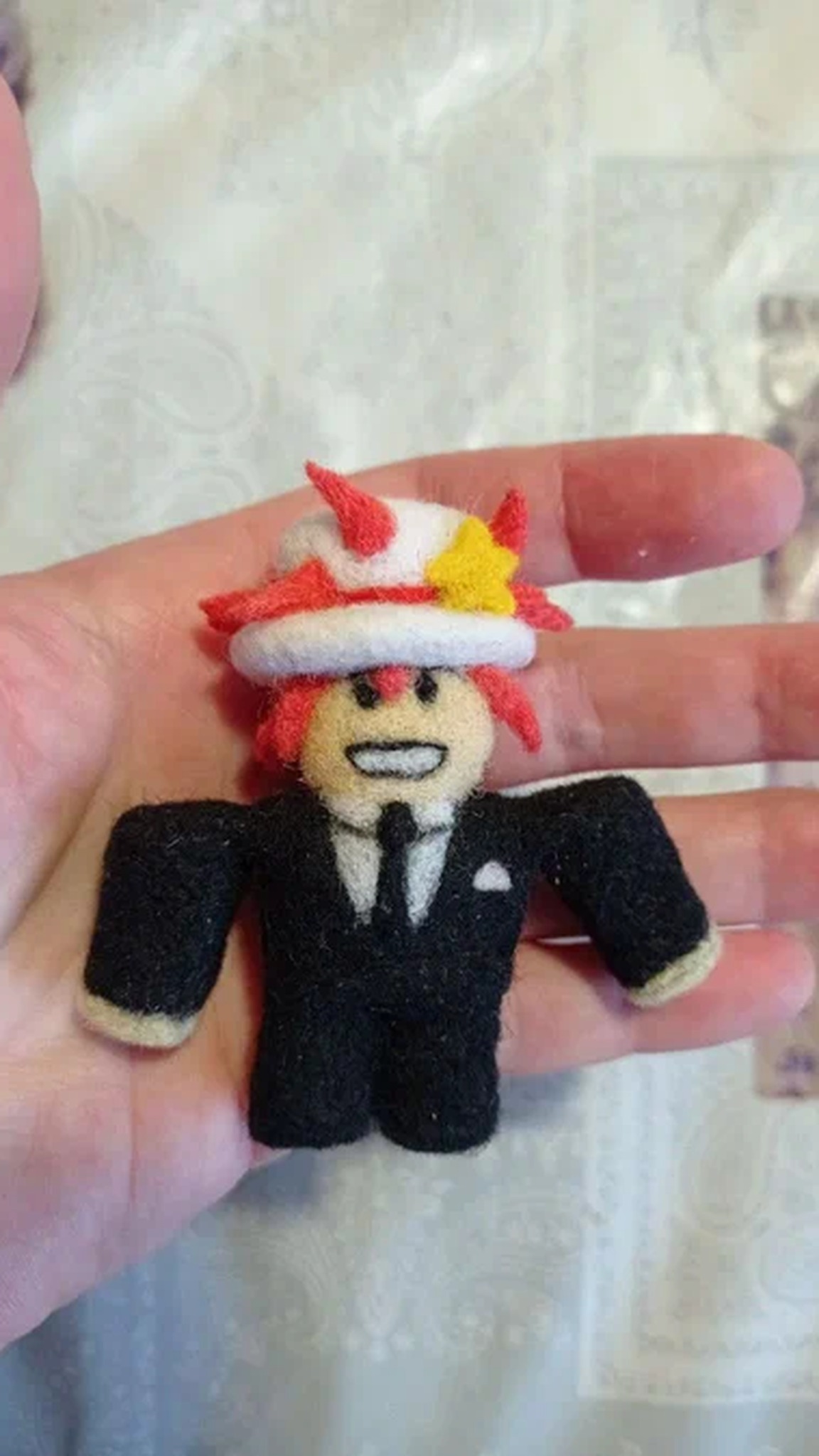 Tiny custom Roblox avatar plush in a black suit and tie with red hair and a white hat, handmade to order