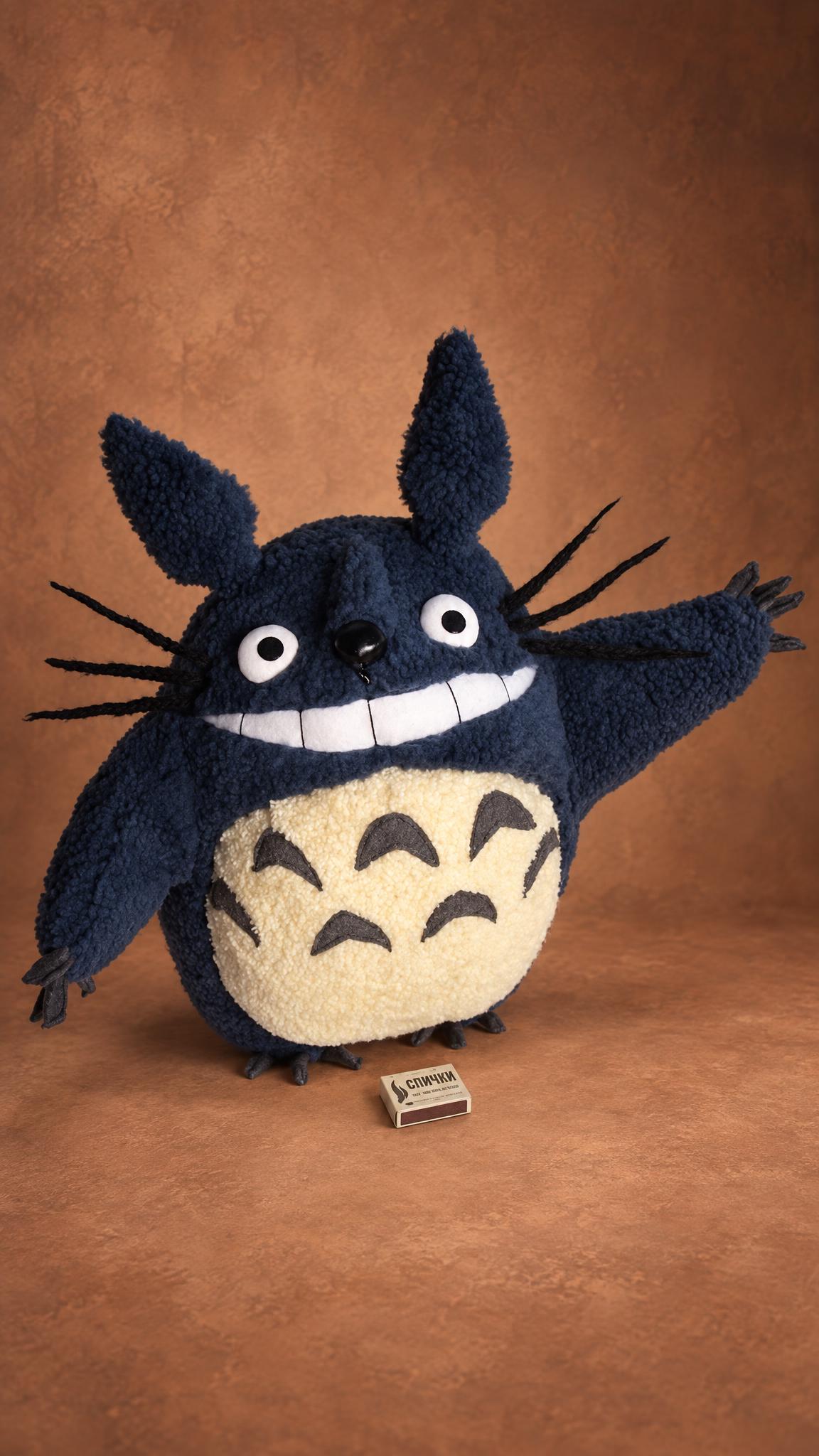Navy blue Totoro plush, one of our first handmade toys, 2009: curly navy fleece, a white grin, cream belly