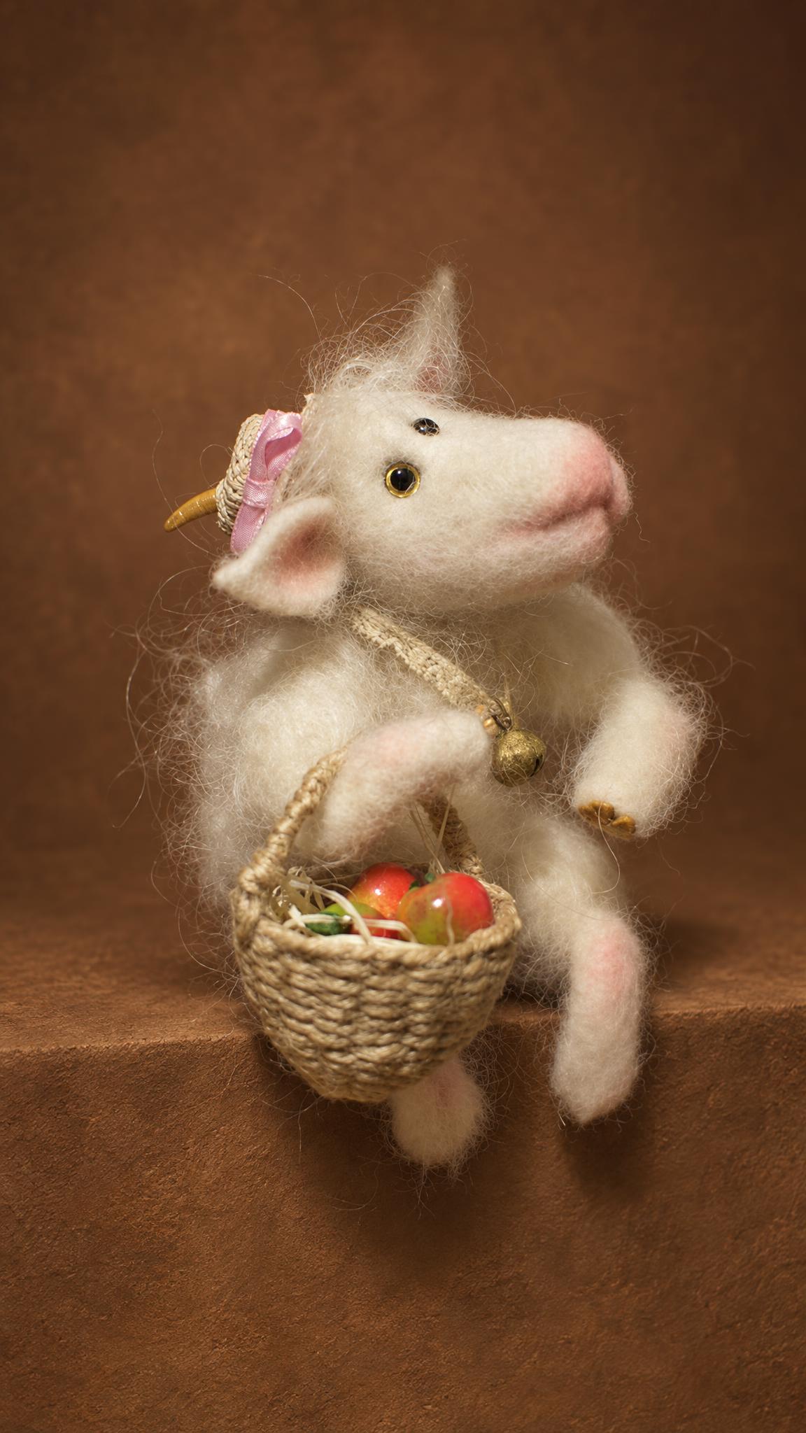 Felted goat toy made to order, golden horns, pink ribbon on a straw hat and a basket of apples in her hoof