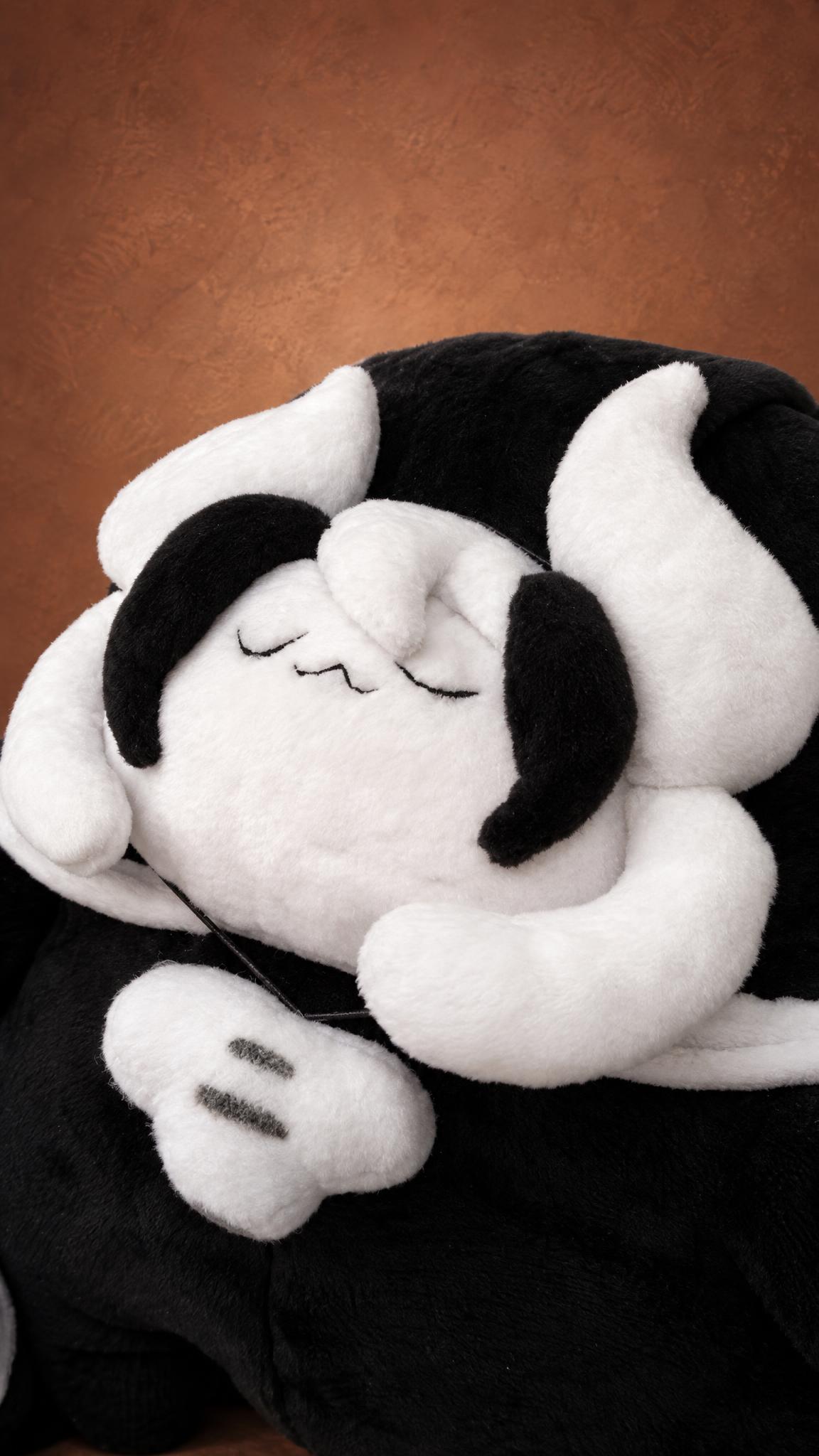 Custom Ozen plush face: embroidered closed eyes, a tiny cat mouth and the white charm on a cord, made to order