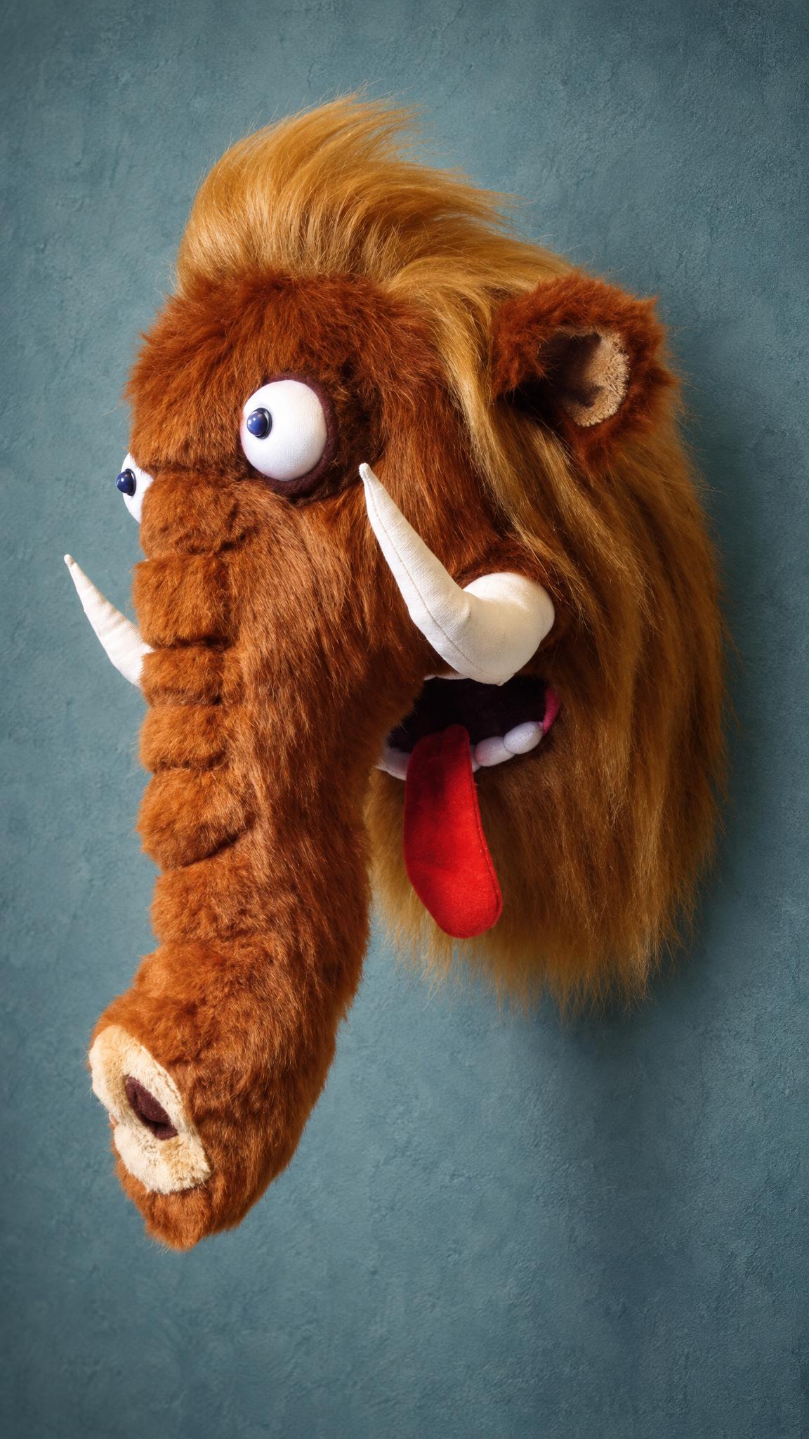 Plush woolly mammoth head wall mount, our first handmade build from 2012: blond tuft, soft tusks, red tongue