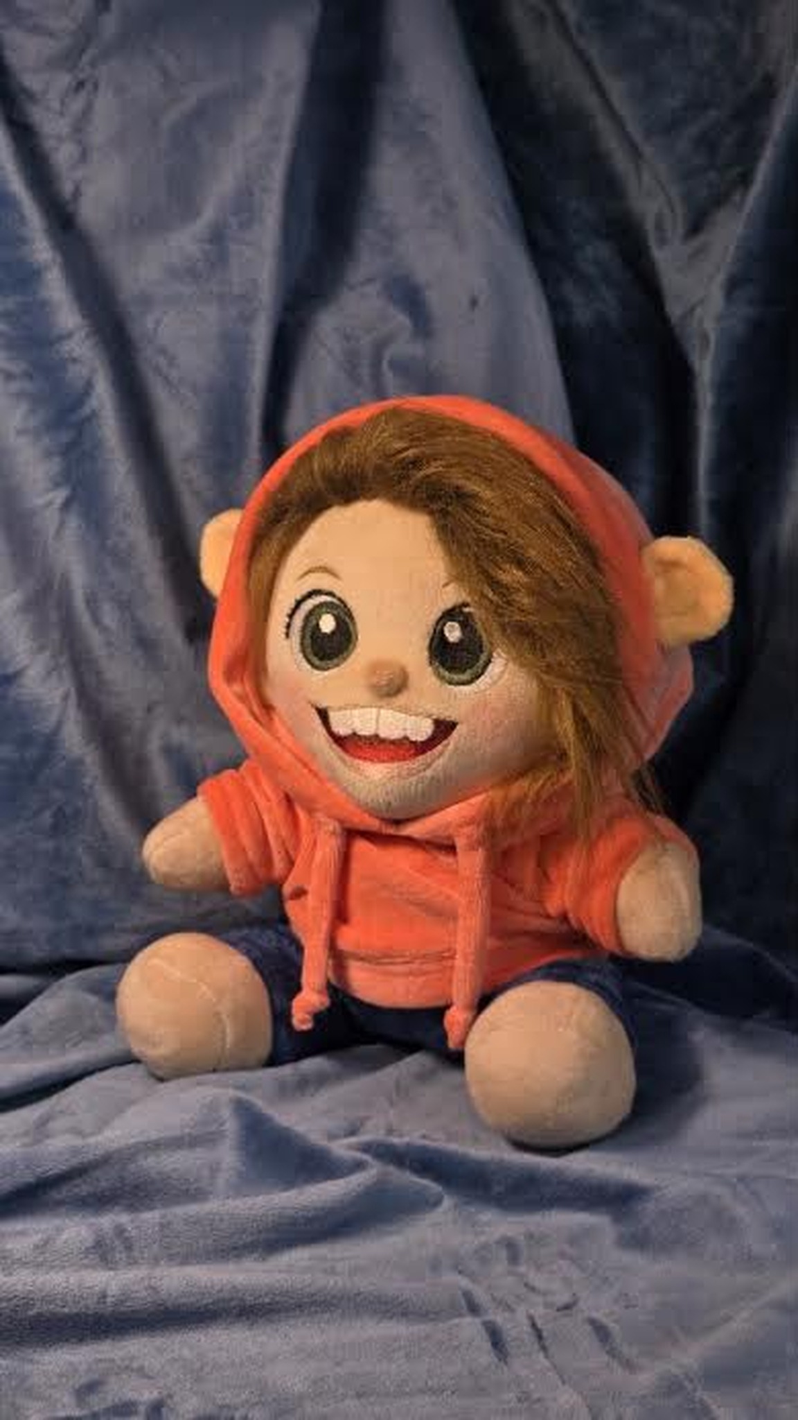 Handmade plush portrait doll sitting in an orange hoodie and navy trousers, made to order from photos