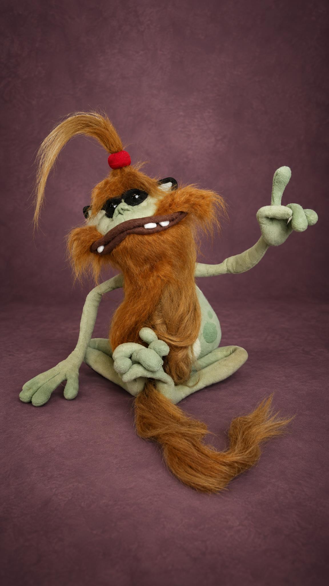 Polokus plush from Rayman 2 with a long ginger faux-fur beard and tail and black sunglasses, a custom plush