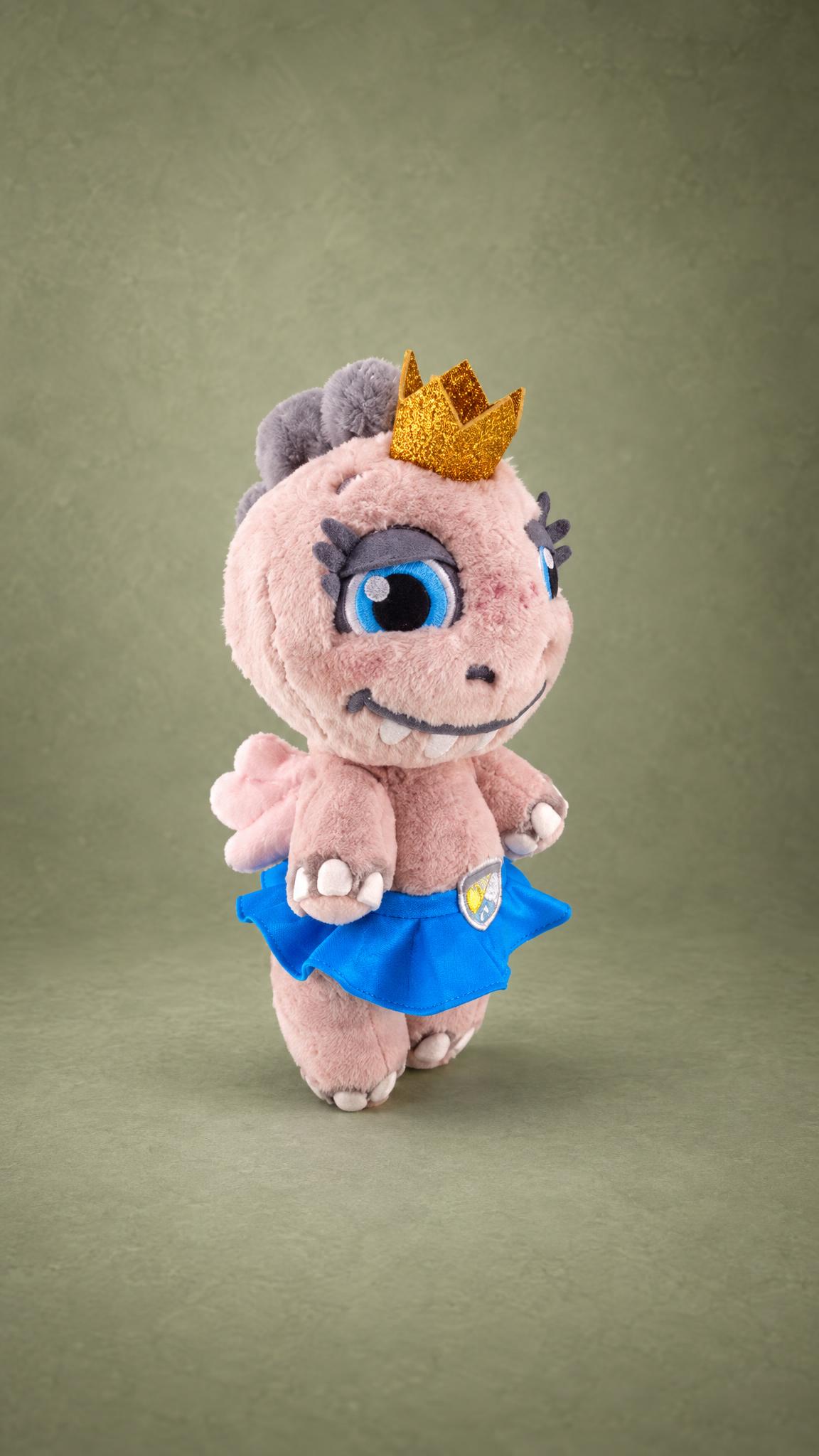 Custom kawaii dinosaur plush in a blue skirt and gold crown, pink faux fur and blue eyes, sewn to order