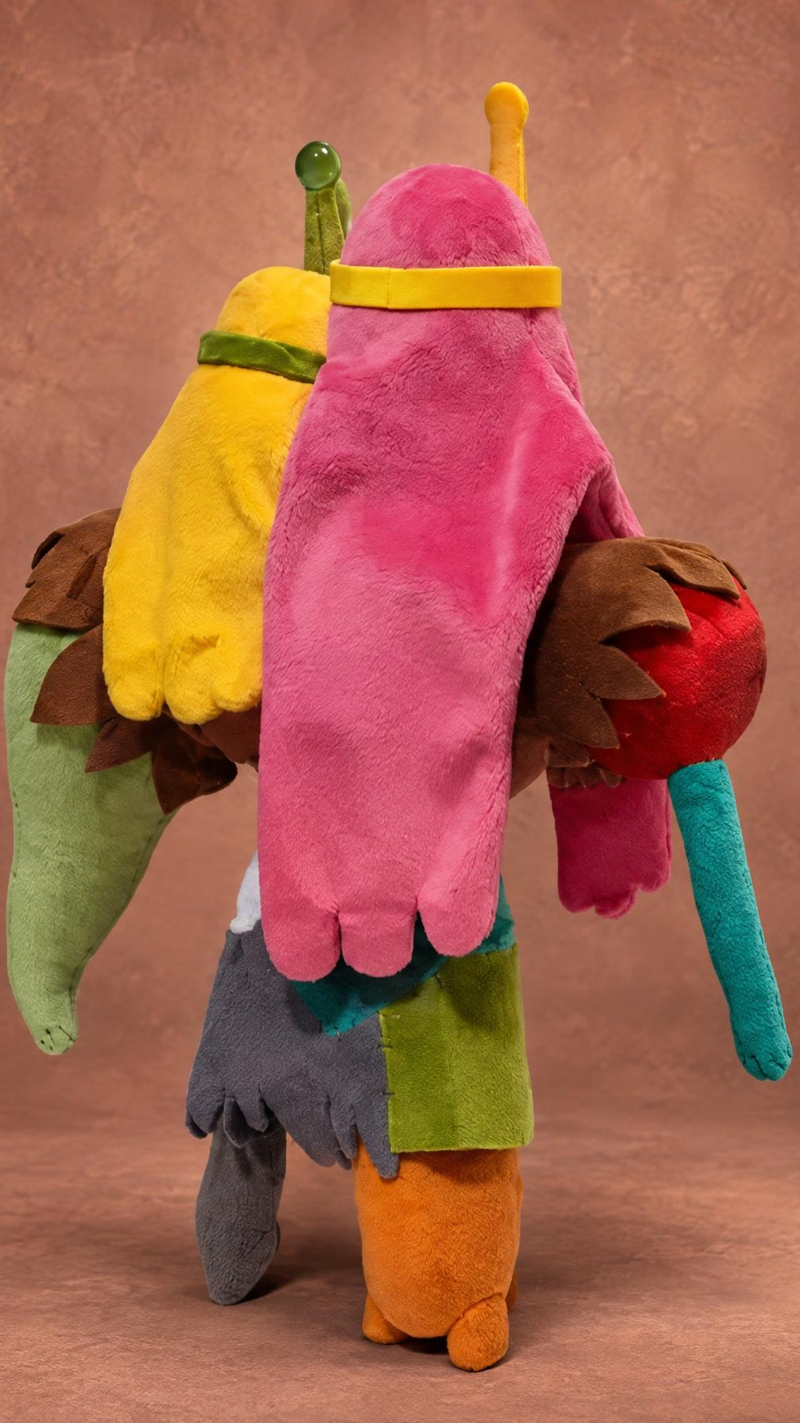 Princess Monster Wife plush from behind, long pink hair and a yellow arm, an Adventure Time plush sewn to order