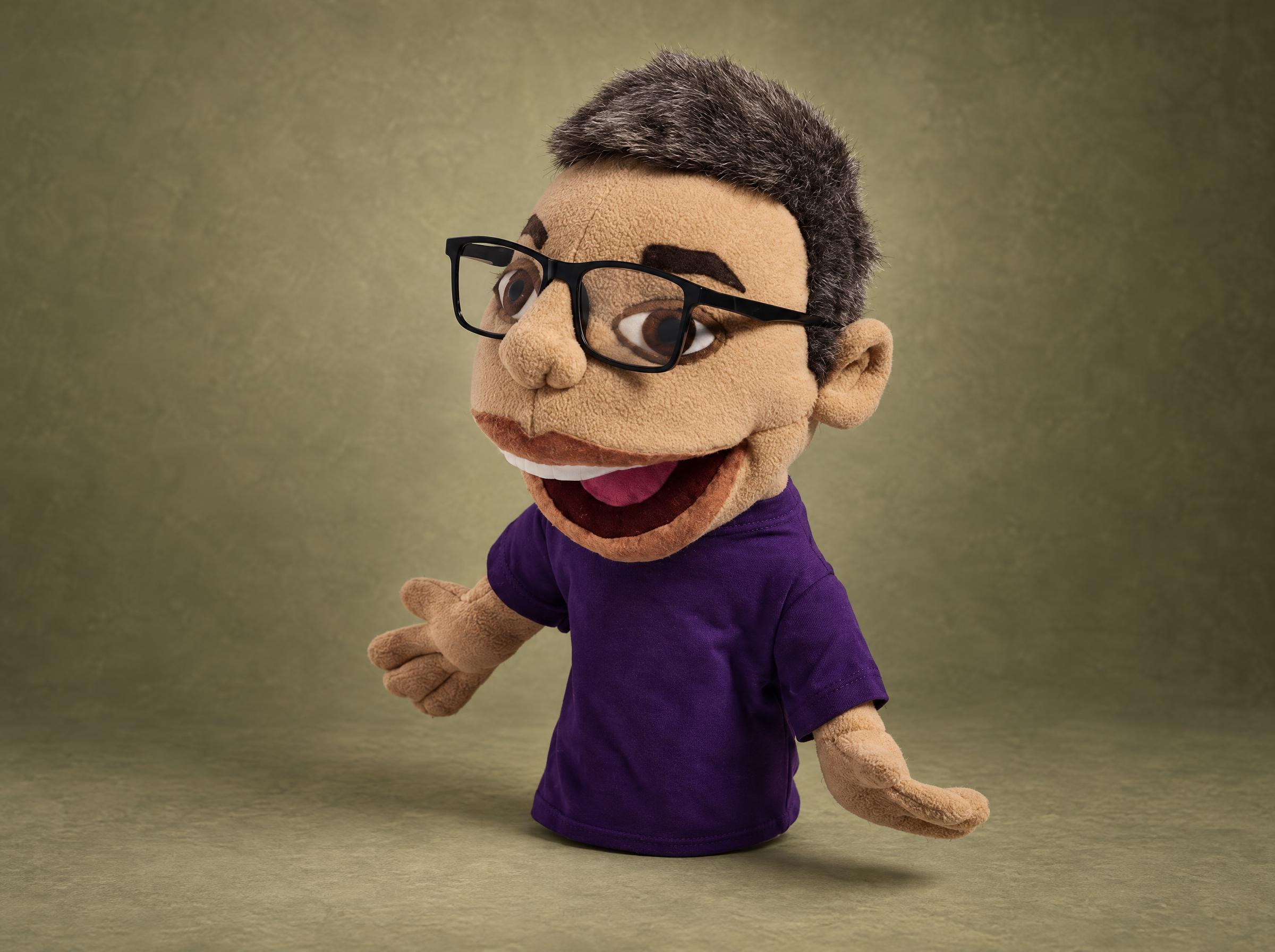 Custom hand puppet of a real blogger: gray hair, black glasses, purple T-shirt, made to order from photos