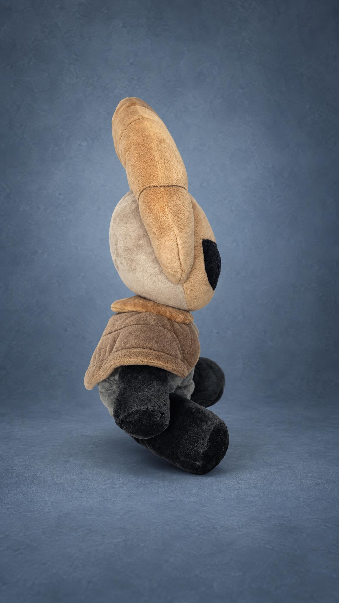Handmade Radiance plush from Hollow Knight in profile, with its tall tan crest and short cape, custom made