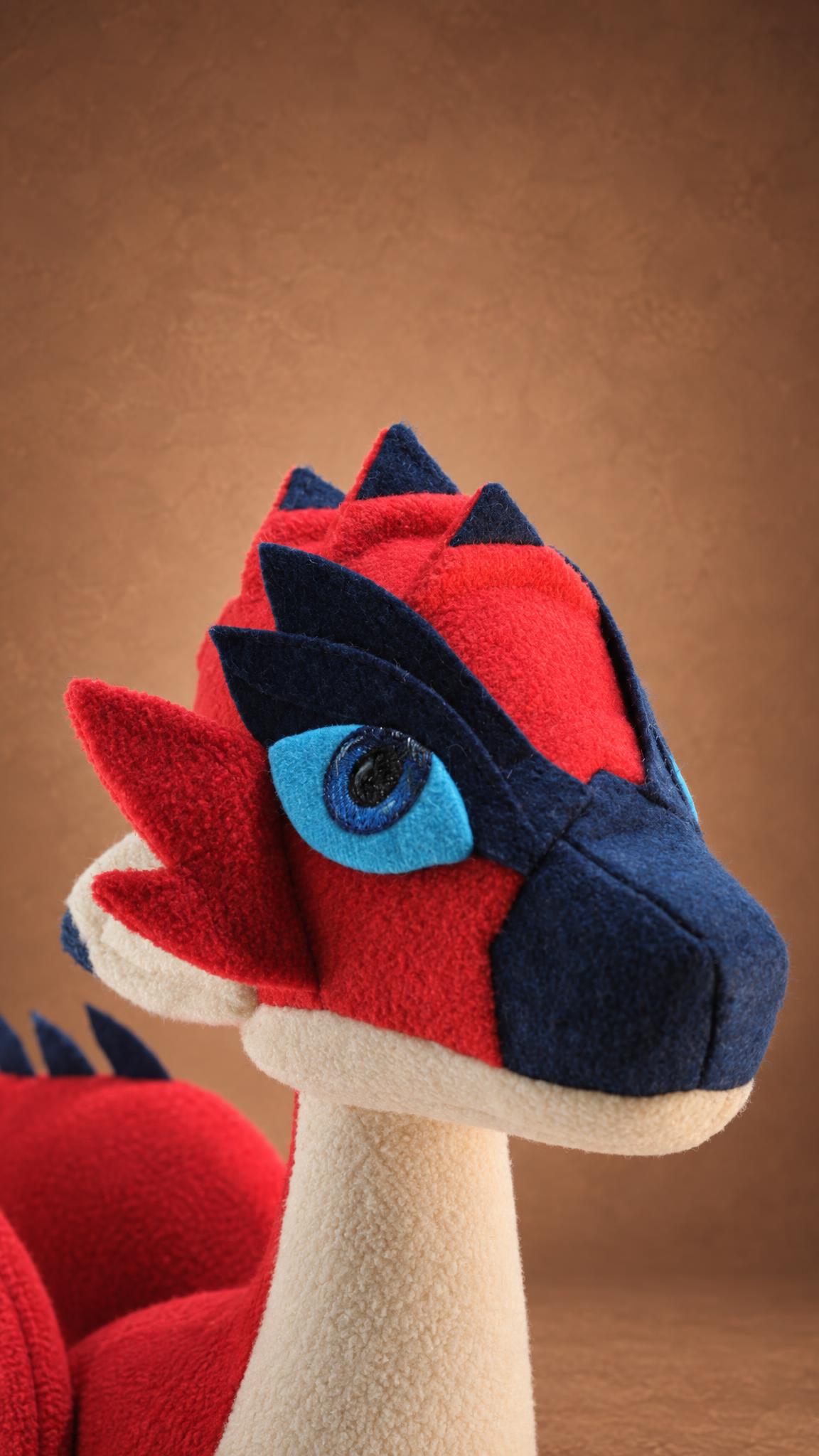Handmade Rathalos plush head detail, navy plates and stitched eye, custom wyvern