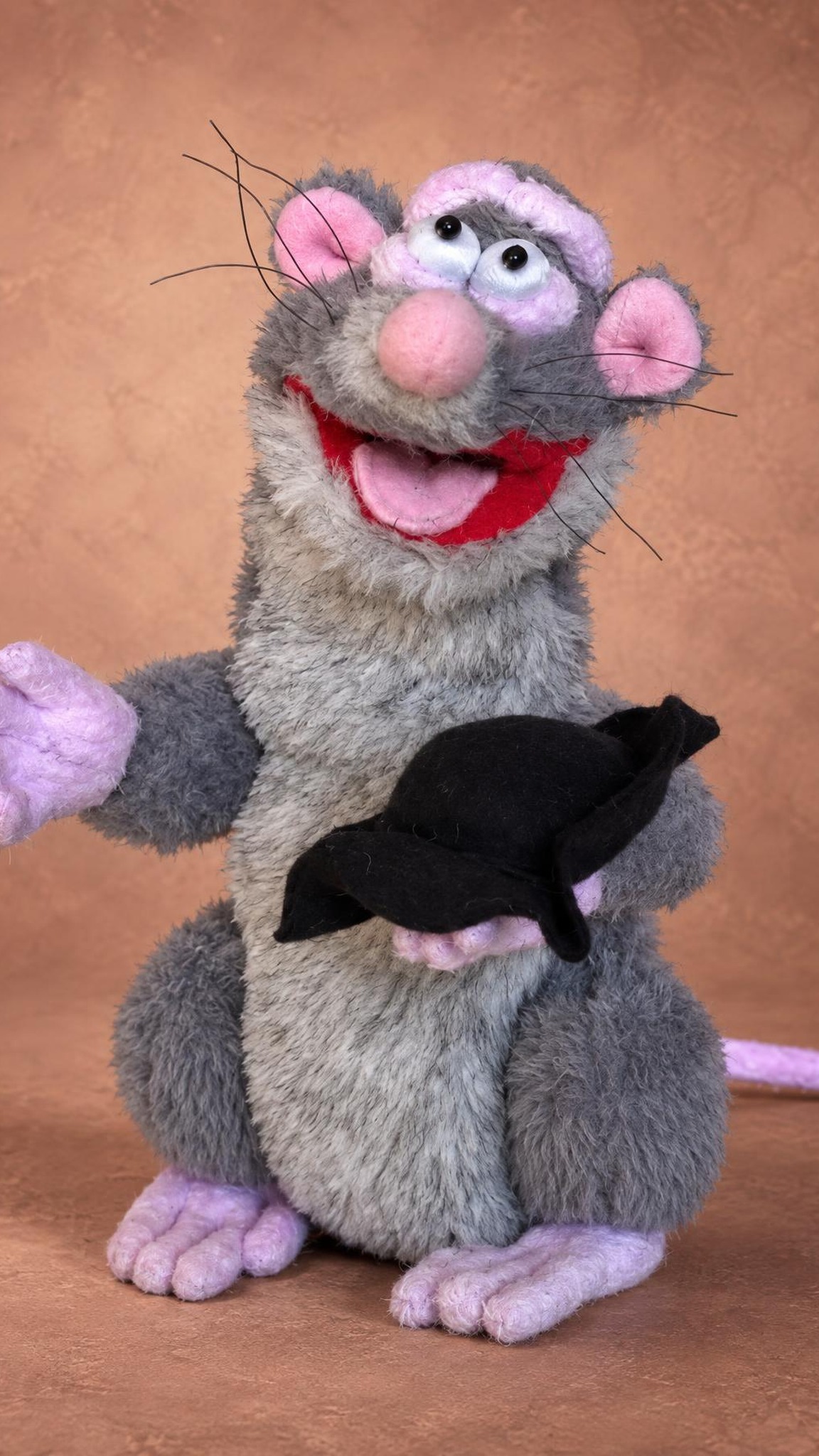 Rattus Rattus plush holding his removable black cap, a Horrible Histories rat sewn by hand to order