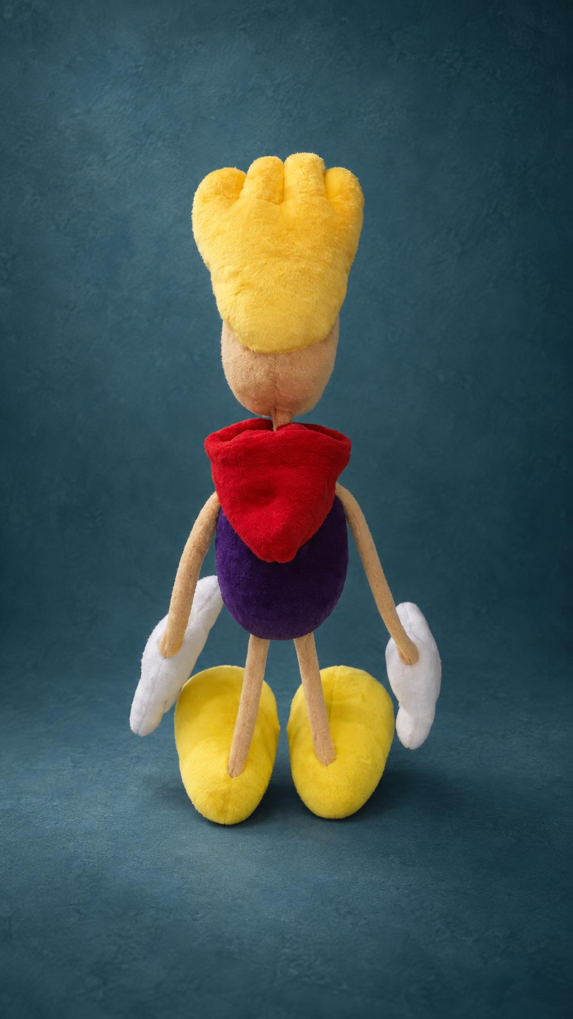 Rayman plush hair tuft in bright yellow pile above a red hood and purple body, a custom handmade Rayman toy