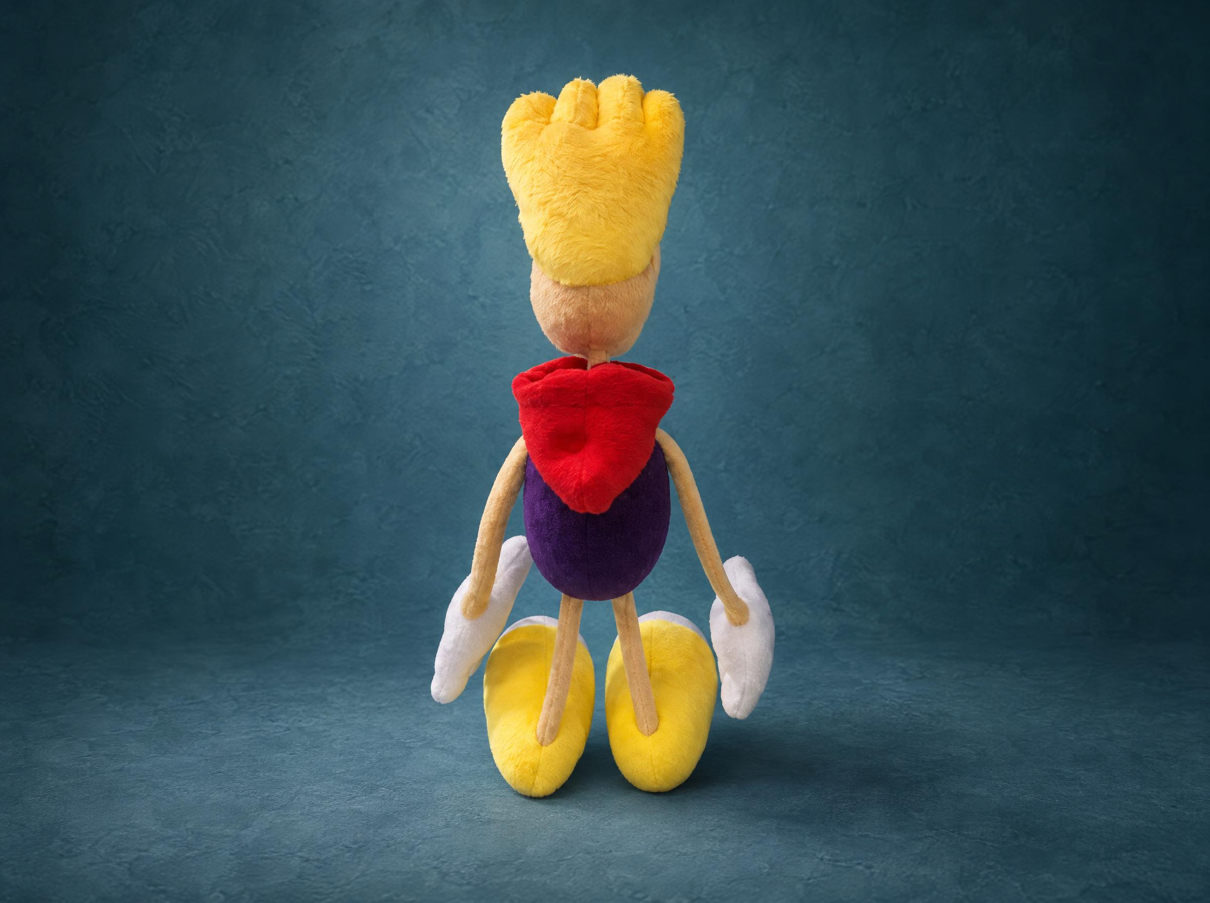 Rayman Plush Hair Tuft and Red Hood Rayman plush hair tuft in bright yellow pile above a red hood and purple body, a custom handmade Rayman toy