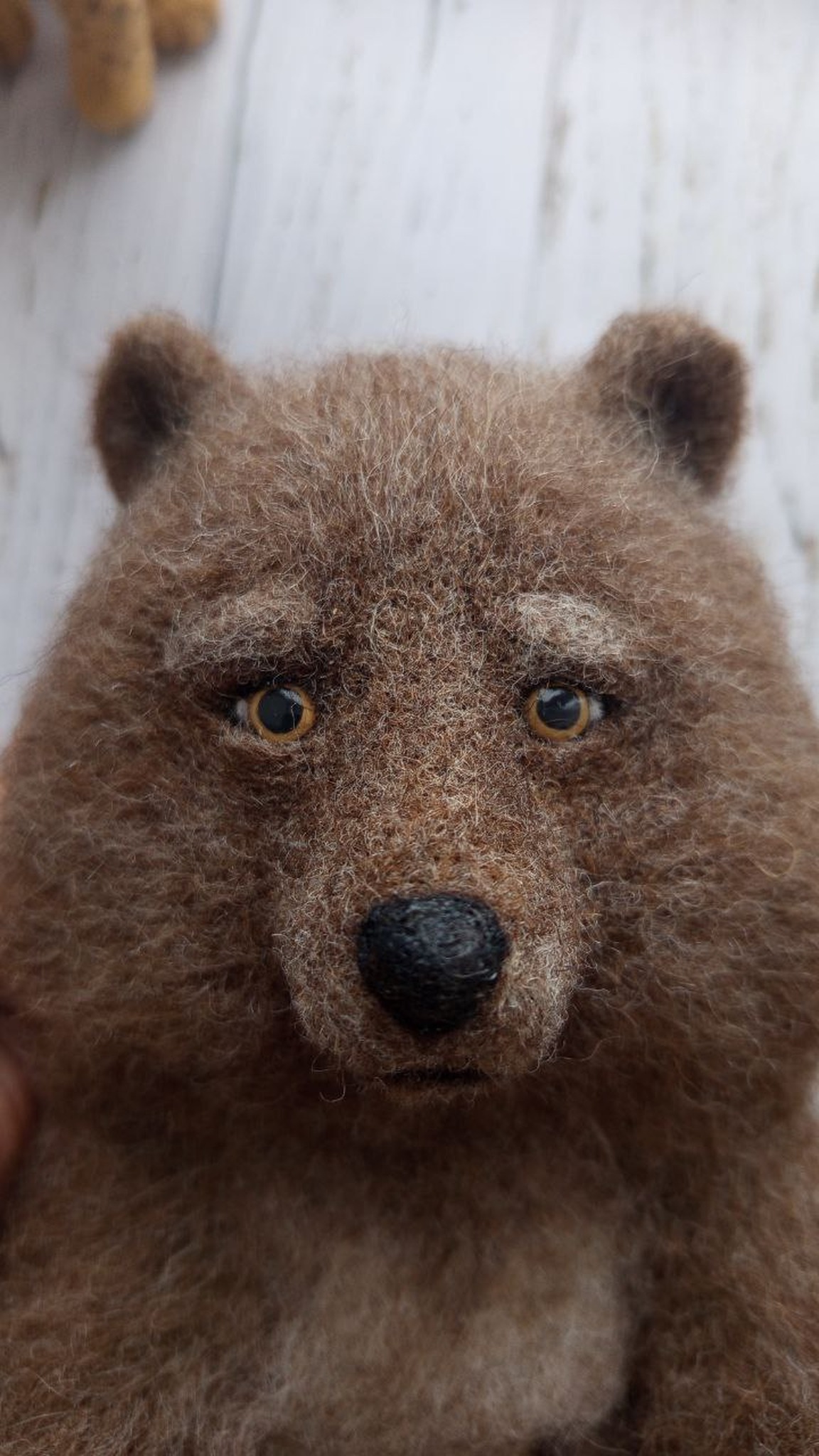 Realistic needle felted bear face with amber eyes, heavy brows and a black nose, handmade to order from wool