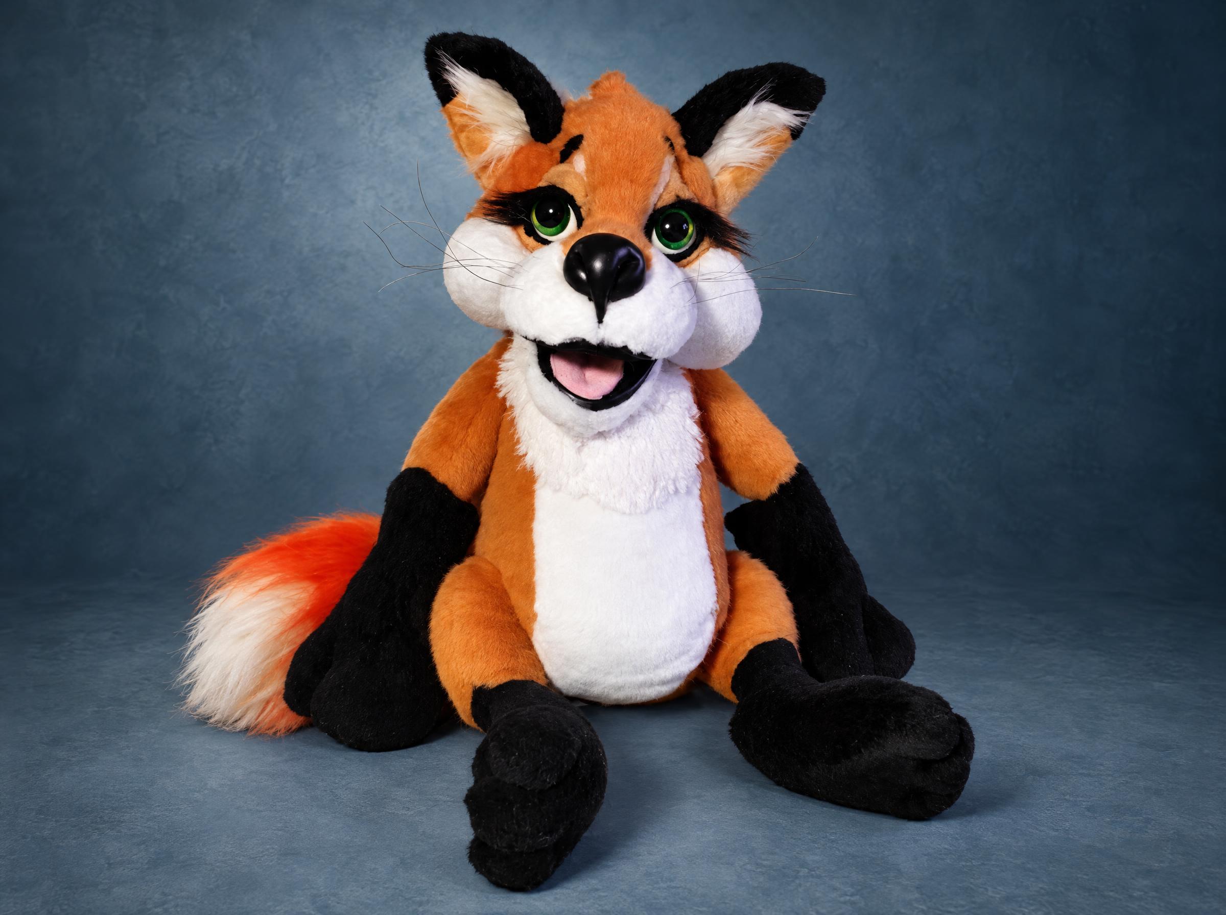 Red fox plush with green eyes, an open smiling mouth, white chest, black paws and a fluffy tail, made to order