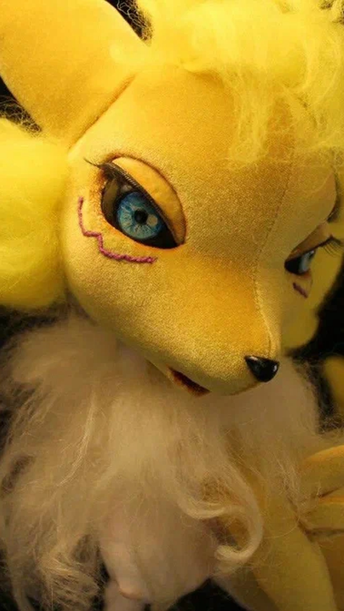 Handmade Renamon doll with bright blue eyes and purple eye markings beside her fluffy tail, a custom Digimon doll