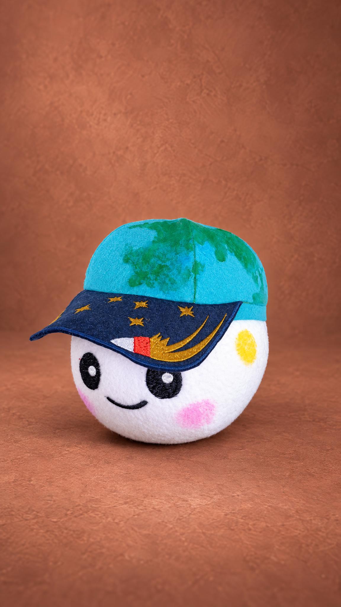 Custom Artemis II Rise plush, handmade: embroidered rocket and gold stars on the navy brim of the Earth cap