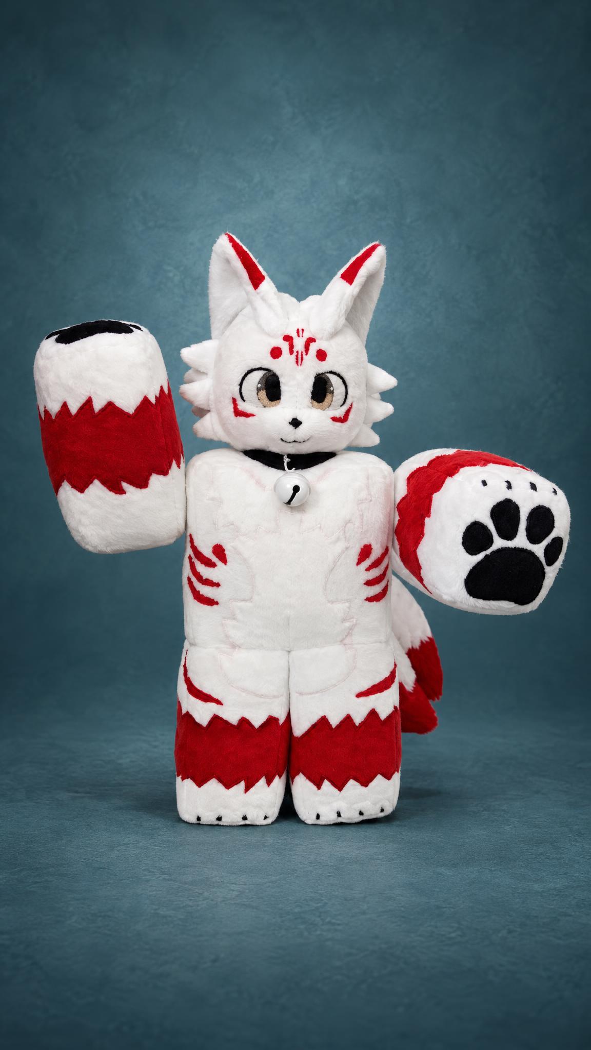Handmade Roblox fox plush waving a paw with black paw pads, white faux fur and red stripes, a custom avatar toy