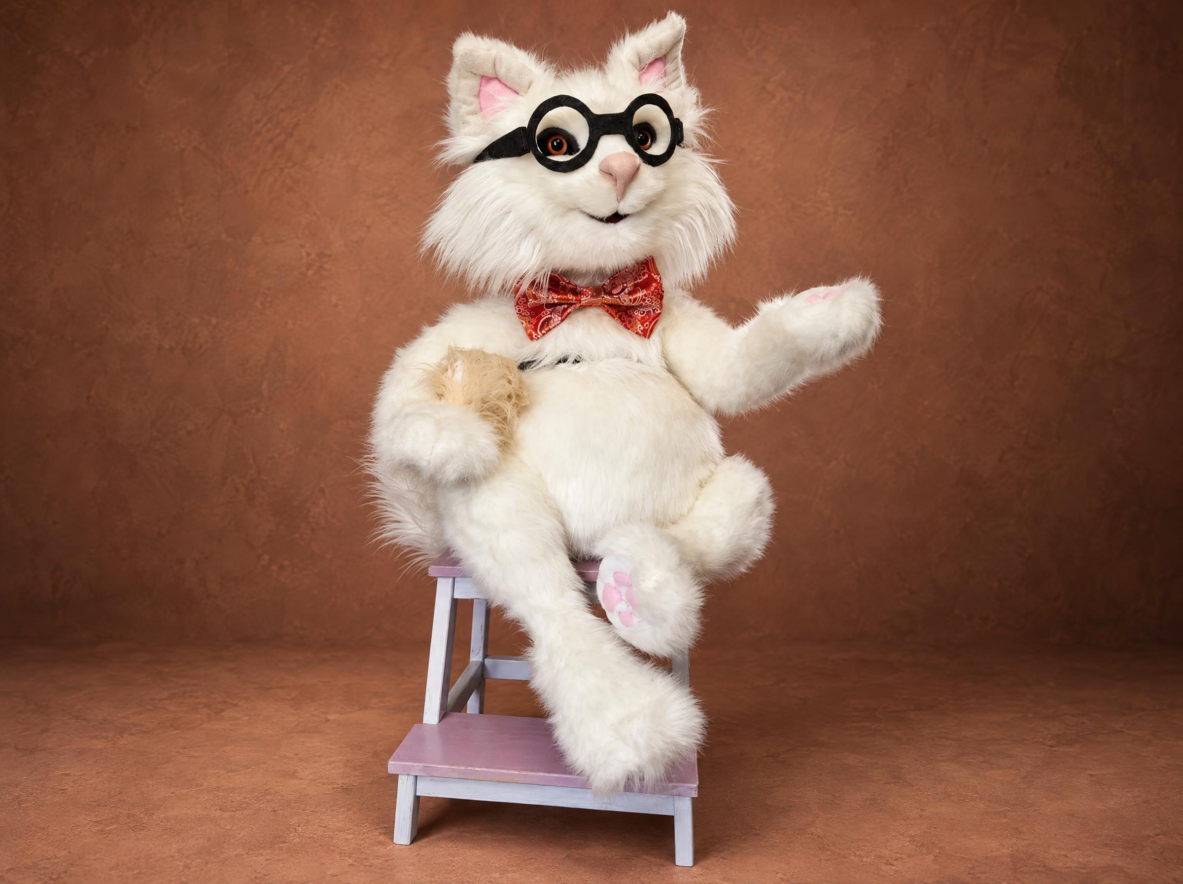 Ronald, a giant white cat plush in black felt glasses and a red bow tie, handmade to order as a gift