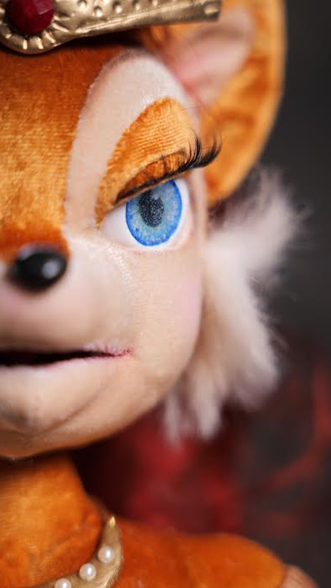Sally Acorn doll face with big blue eyes, long lashes and a black nose, a handmade Sonic collector doll