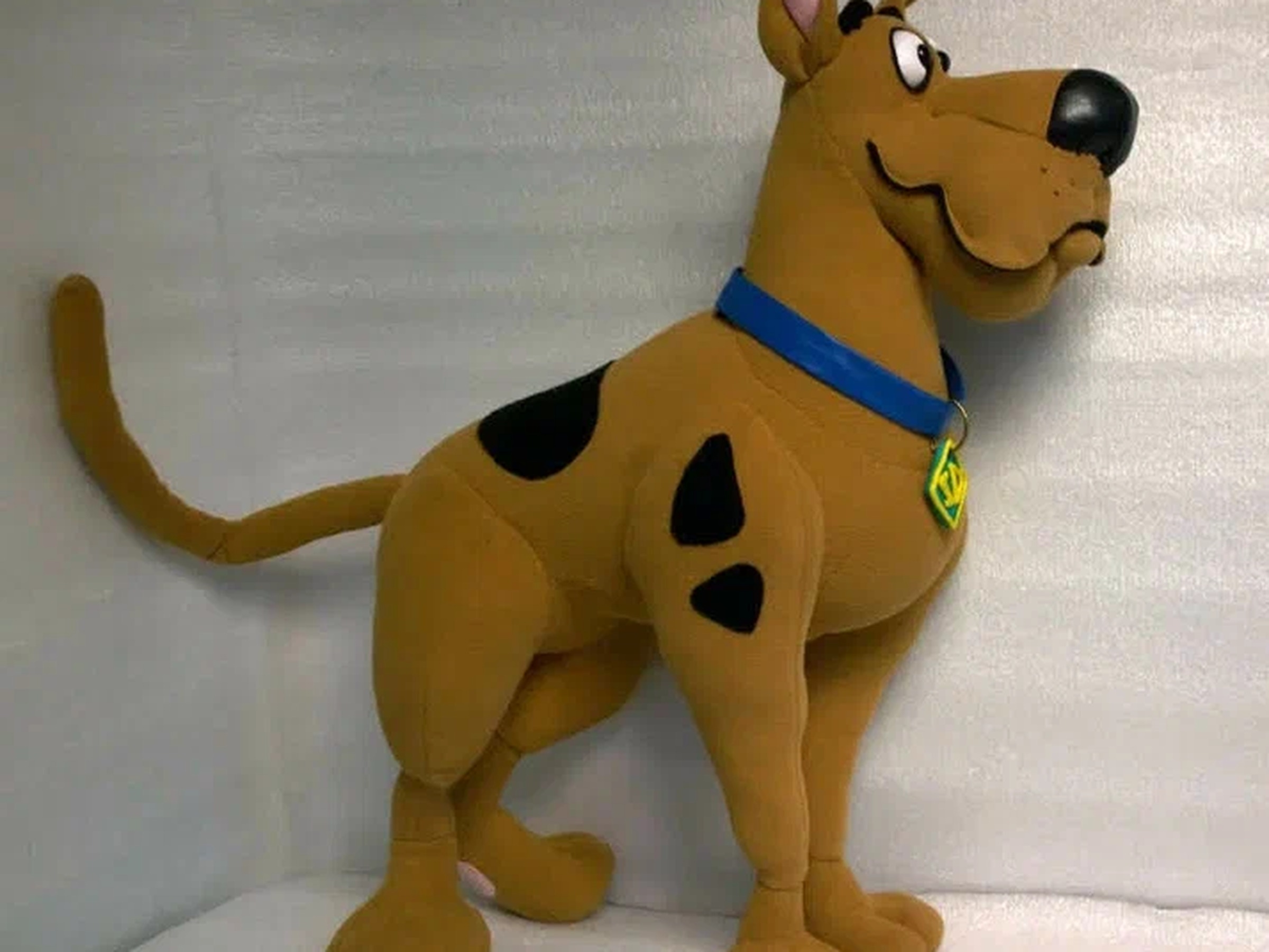Scooby-Doo plush with SD tag, custom Great Dane Scooby-Doo plush with black spots, a long tail and the SD tag on a blue collar, a custom Great Dane toy