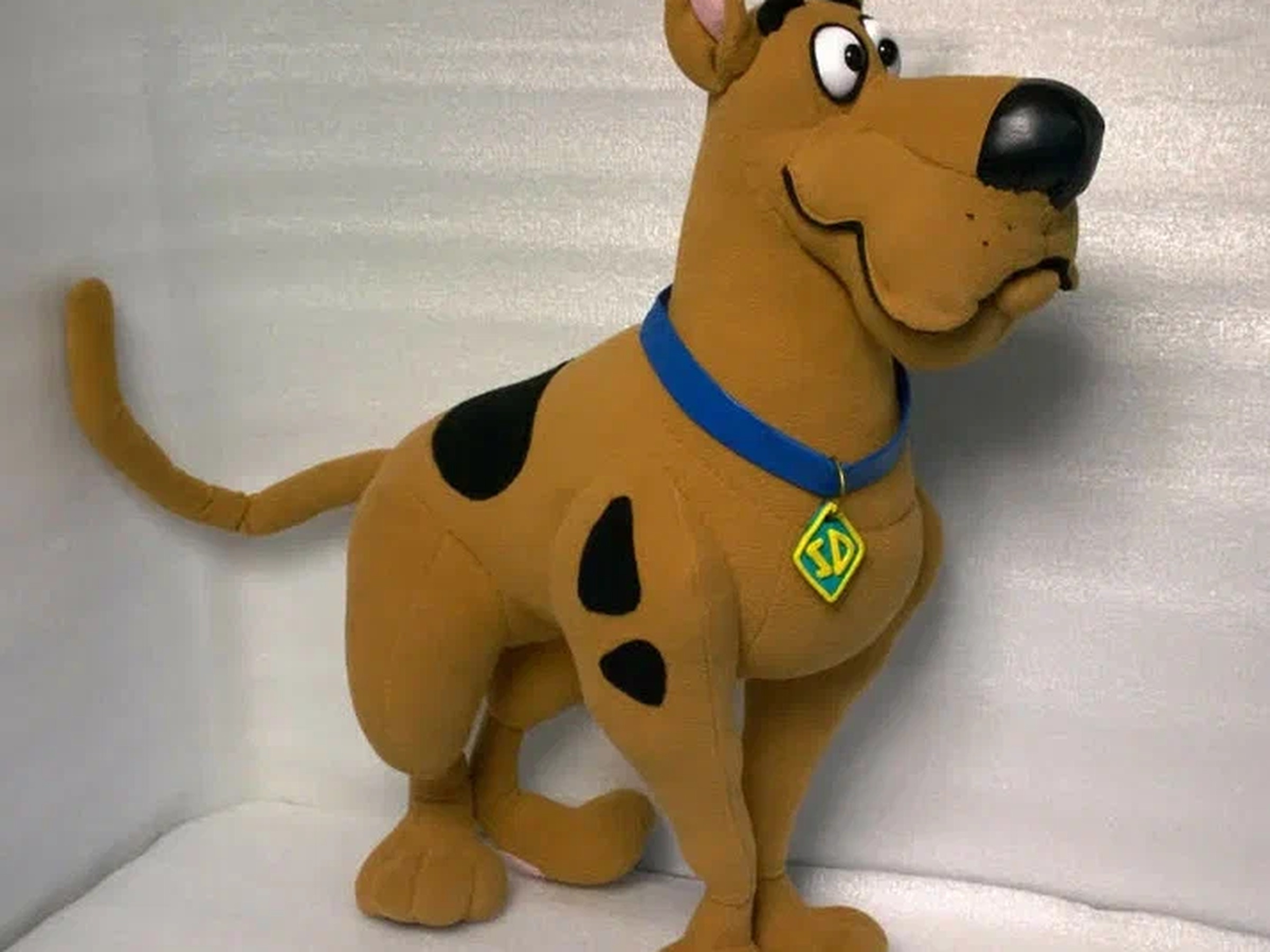 Scooby-Doo plush standing with black spots on brown fleece and a long tail, a custom cartoon dog made to order