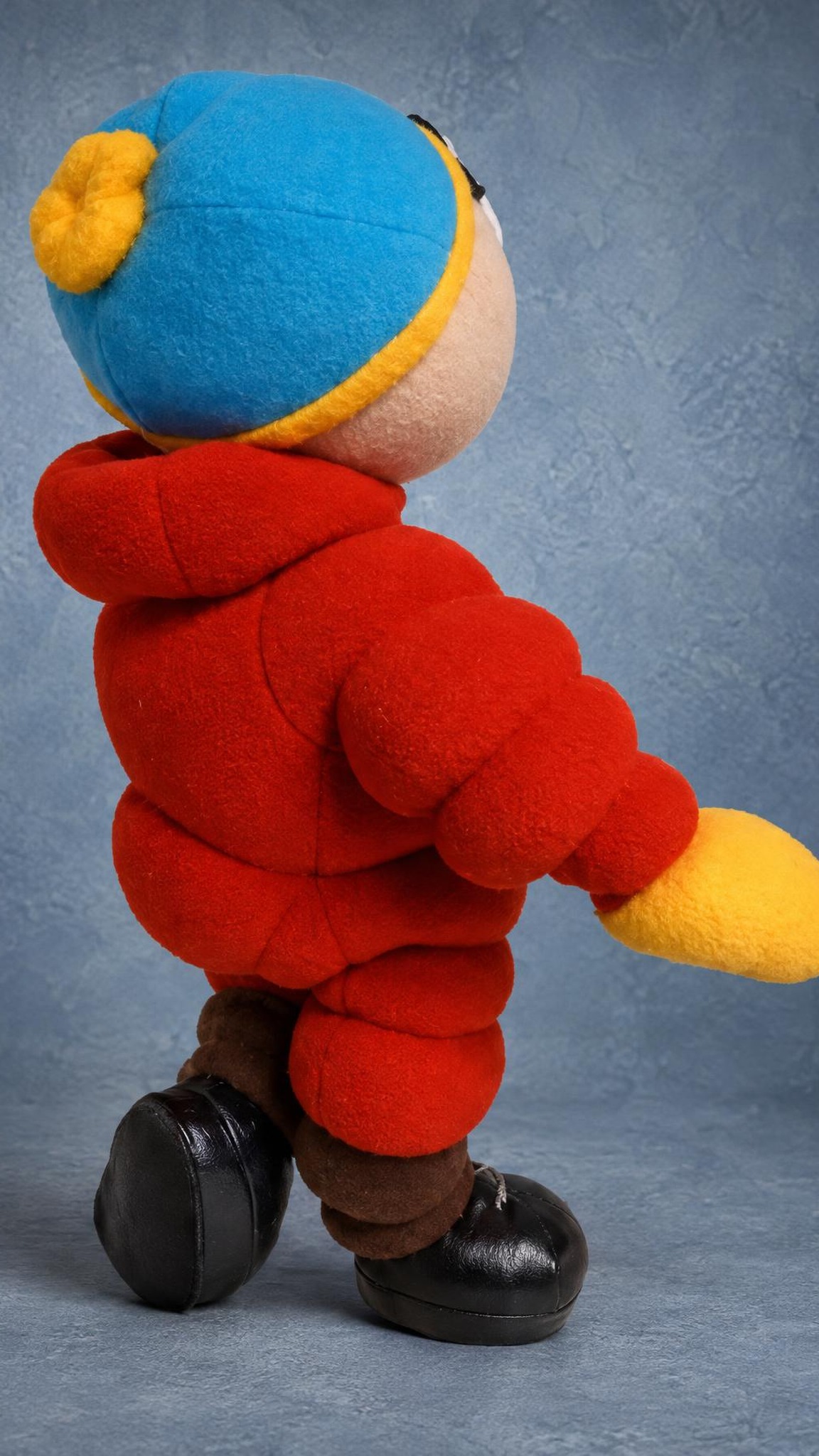 Custom Cartman plush from South Park with a pompom hat and black lace-up shoes, sewn to order