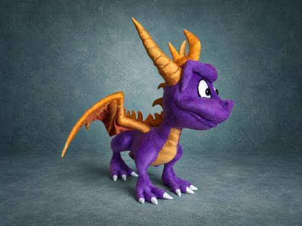 Spyro stuffed animal with one gold wing spread, purple plush and gold horns, a custom handmade Spyro plush