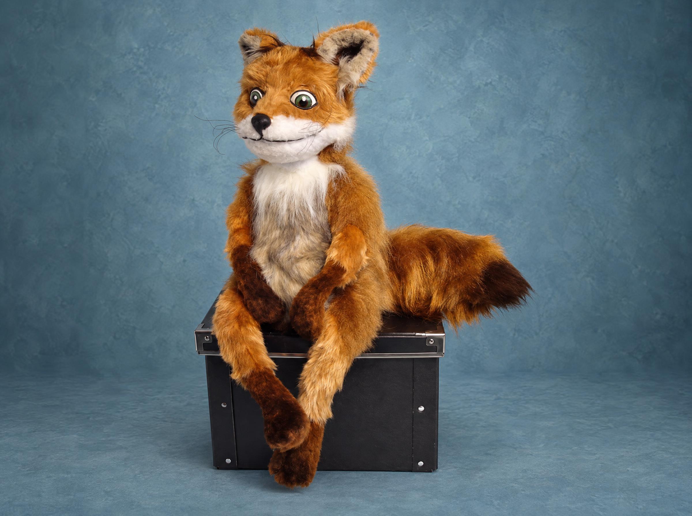Stoned Fox plush made to order in ginger faux fur, with the meme's glassy green eyes, thin grin and long legs