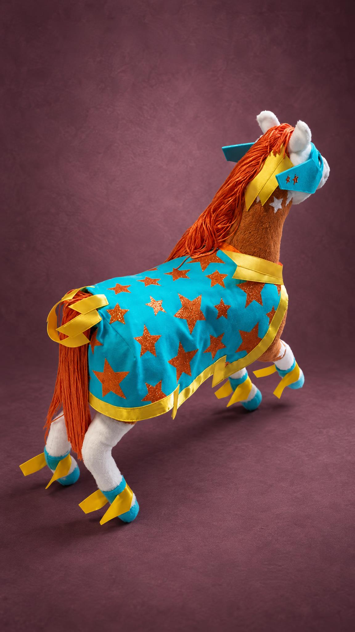 Superhero horse plush with a long orange yarn mane and tail and a turquoise star cape, a custom handmade toy