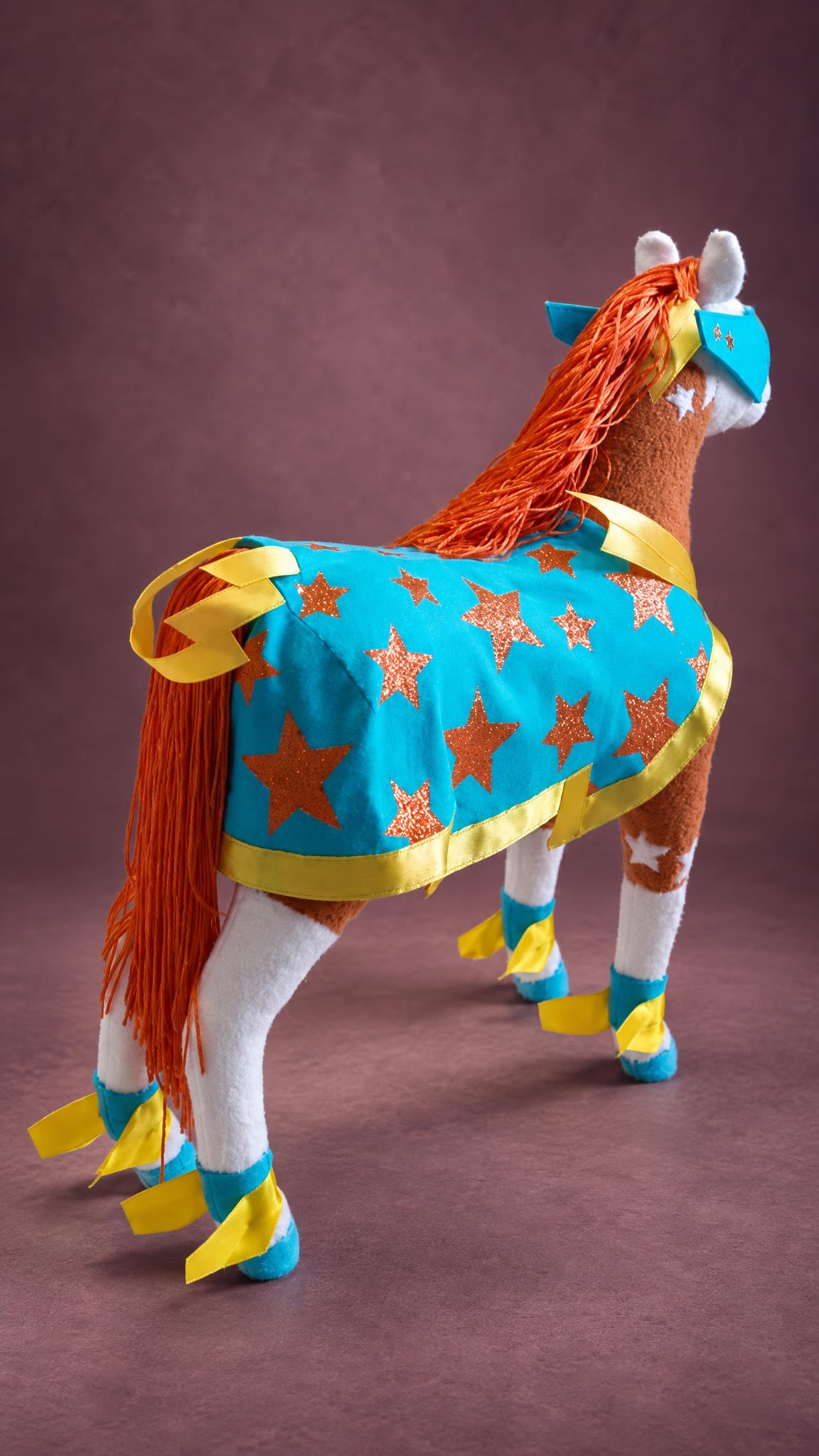 Custom horse soft toy in a turquoise star cape with yellow trim, orange mane and white socks, made to order