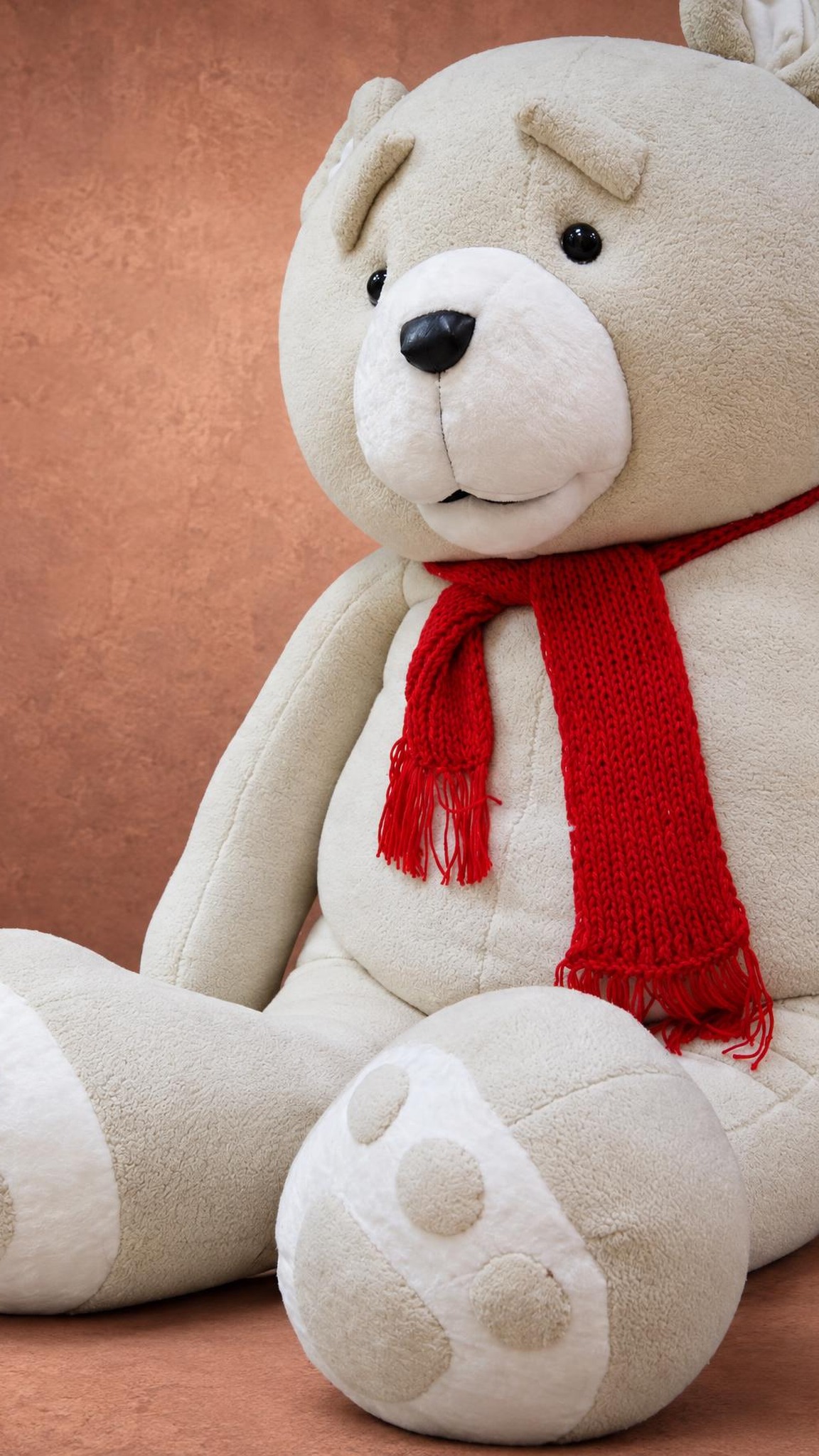 Ted movie bear plush seated with a red knitted scarf, a giant custom teddy sewn by hand to order