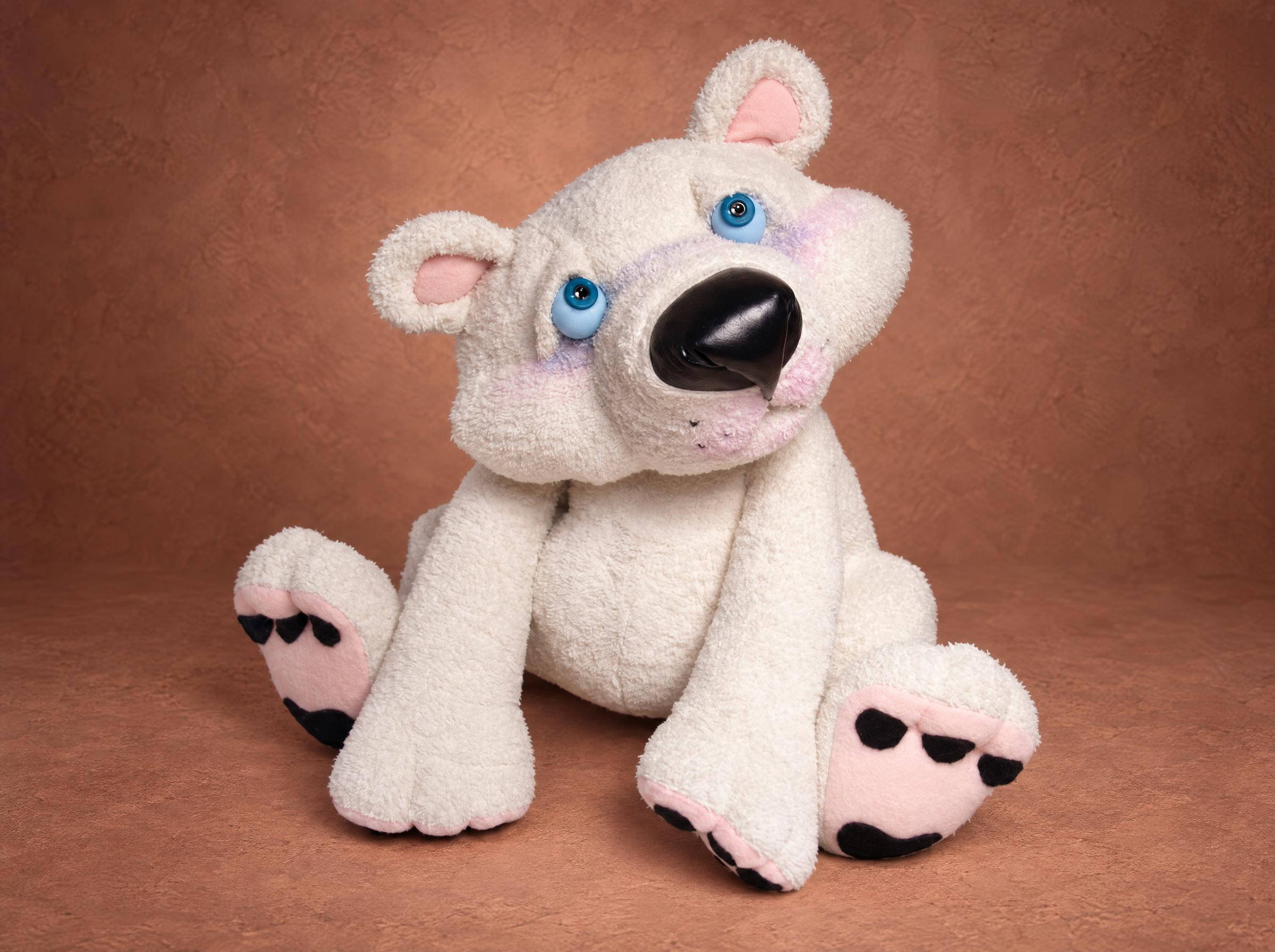 White terrycloth teddy bear sewn from a customer's old robe: blue eyes, a black nose, pink ears and pink paw pads