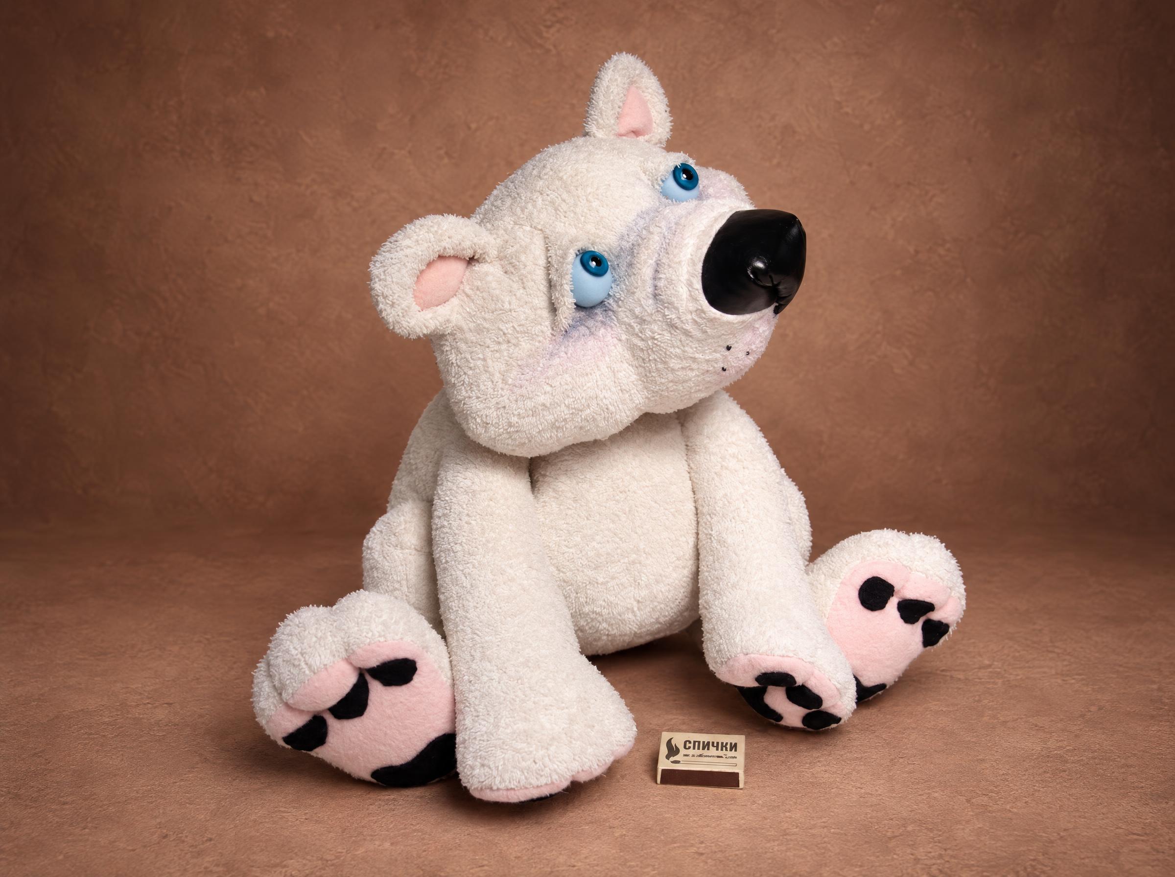 Teddy bear from a robe, sitting White teddy bear from an old robe, sitting with pink paw pads out, blue eyes and a black nose, sewn to order