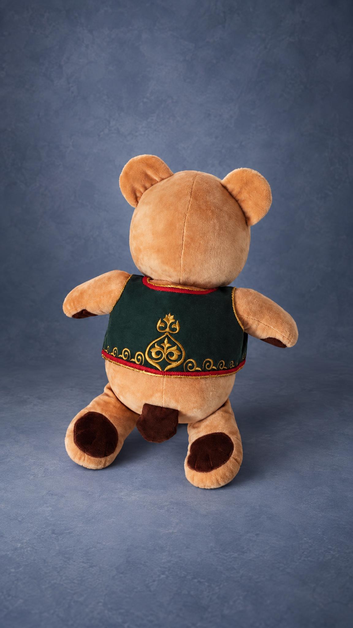 Custom teddy bear prototype from behind: gold ornament embroidered on the green waistcoat, small brown tail
