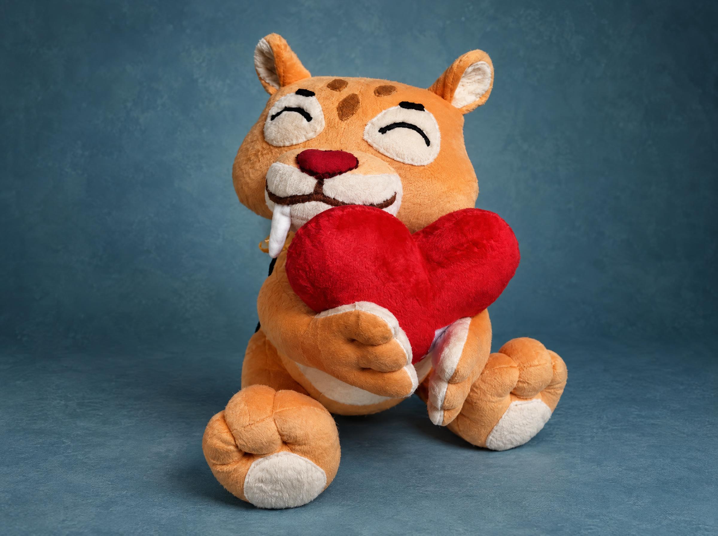 Sticker tiger plush with heart Handmade tiger plush hugging a red heart with white fangs and brown spots, a sticker plush sewn to order