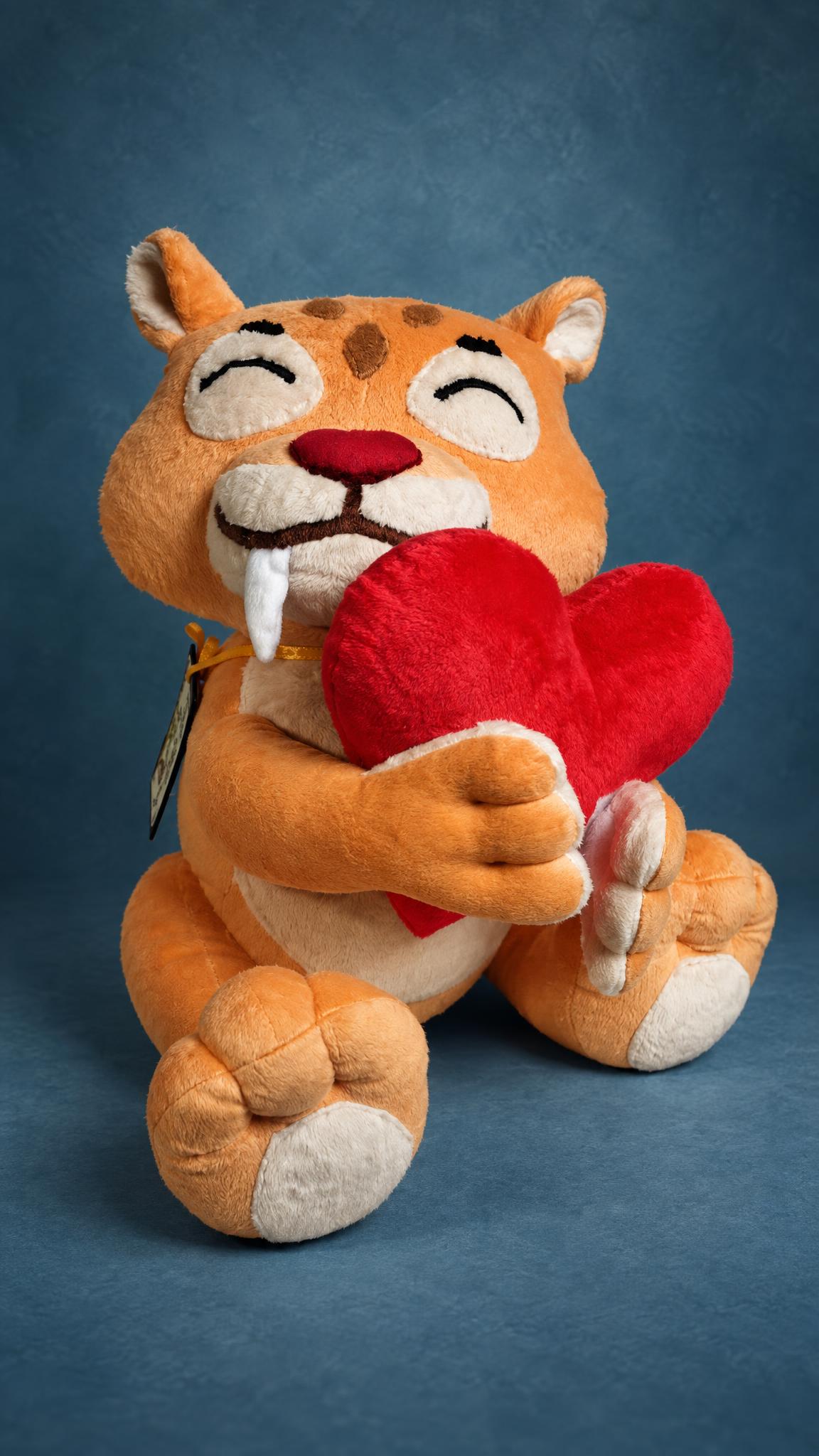 Custom love gift plush: orange saber-tooth tiger hugging a red plush heart, a sticker toy sewn to order