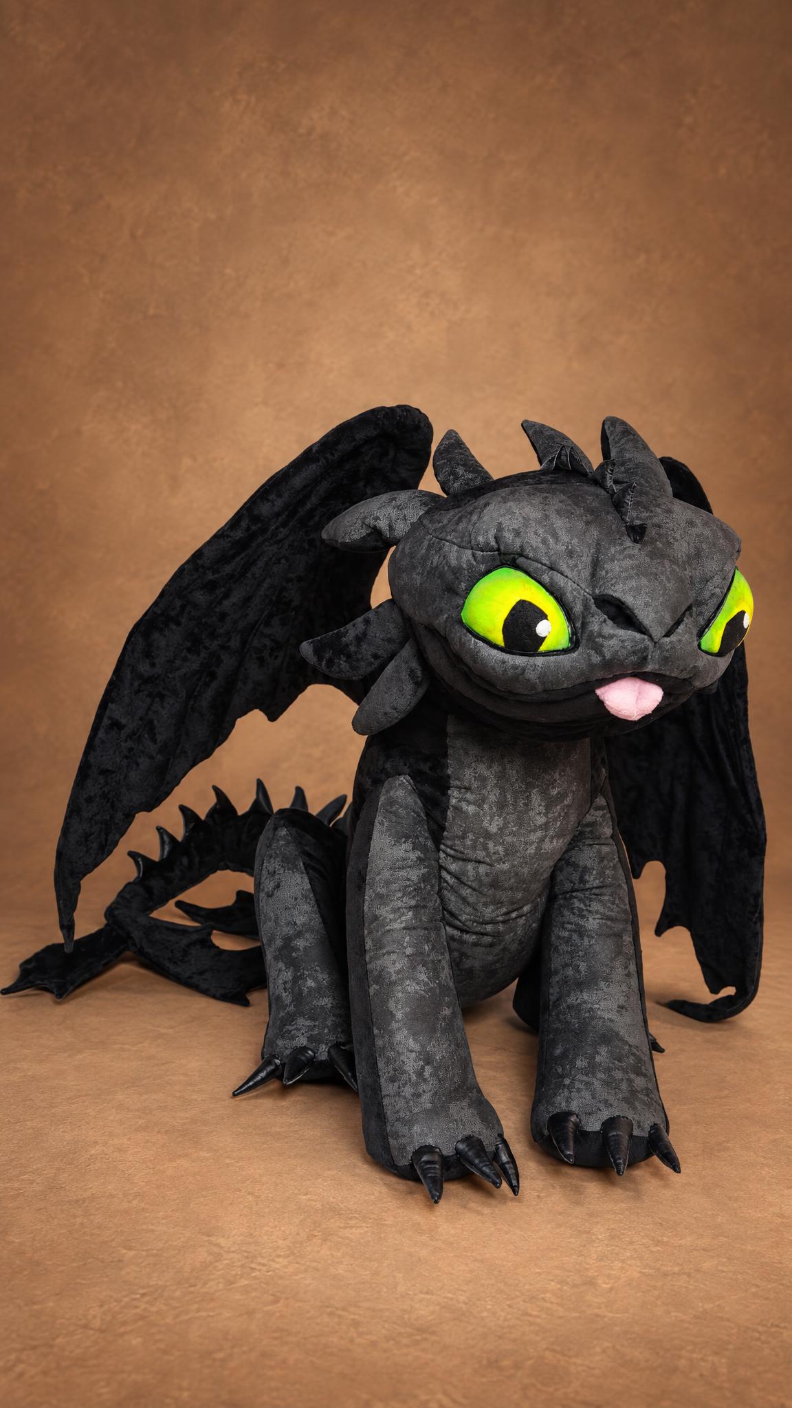 Cheeky Toothless stuffed animal with a pink tongue, mottled charcoal fleece and wings up, custom made