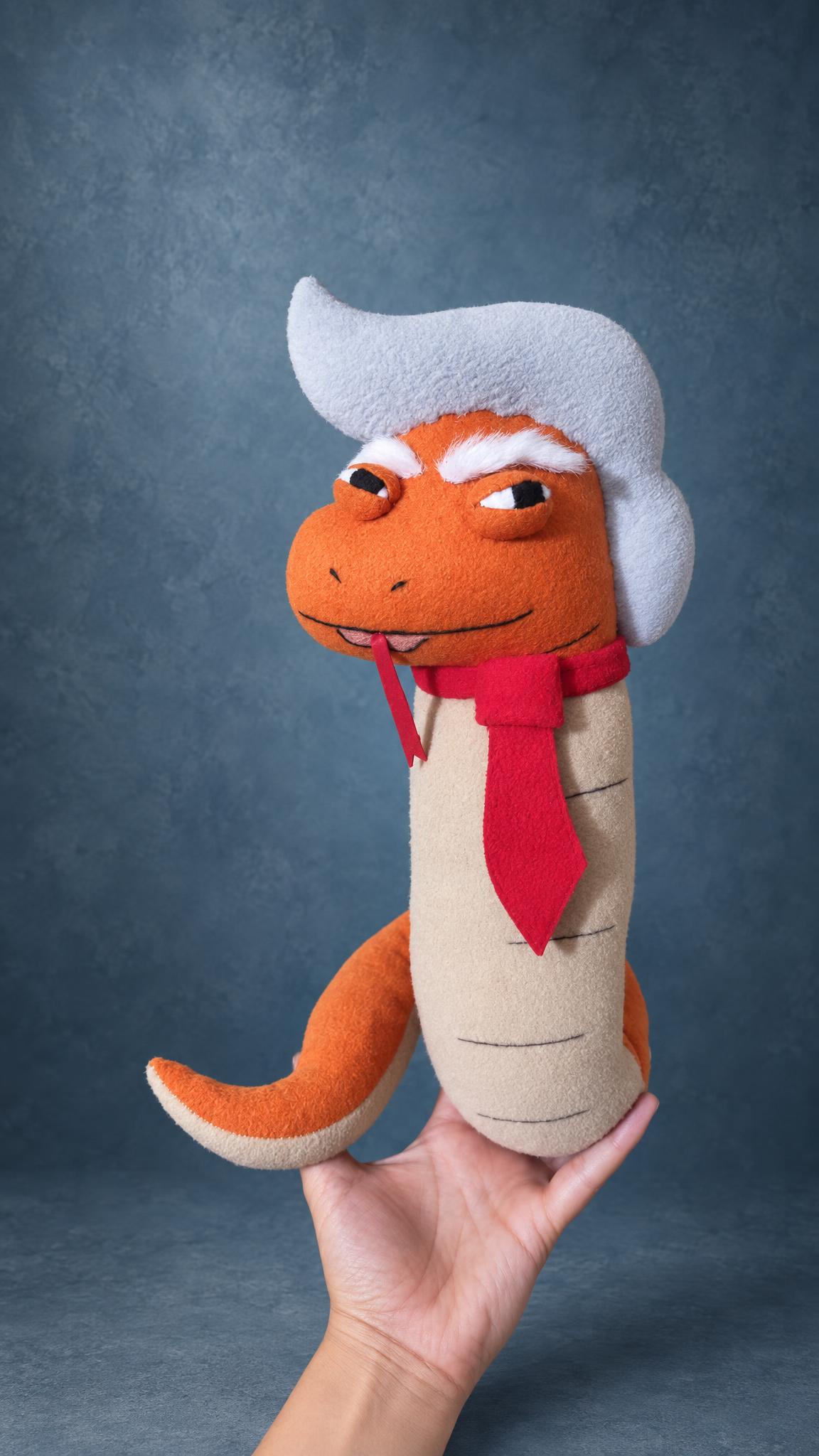 Custom Trump snake plush with white hair and a red tie, a political parody toy handmade to order
