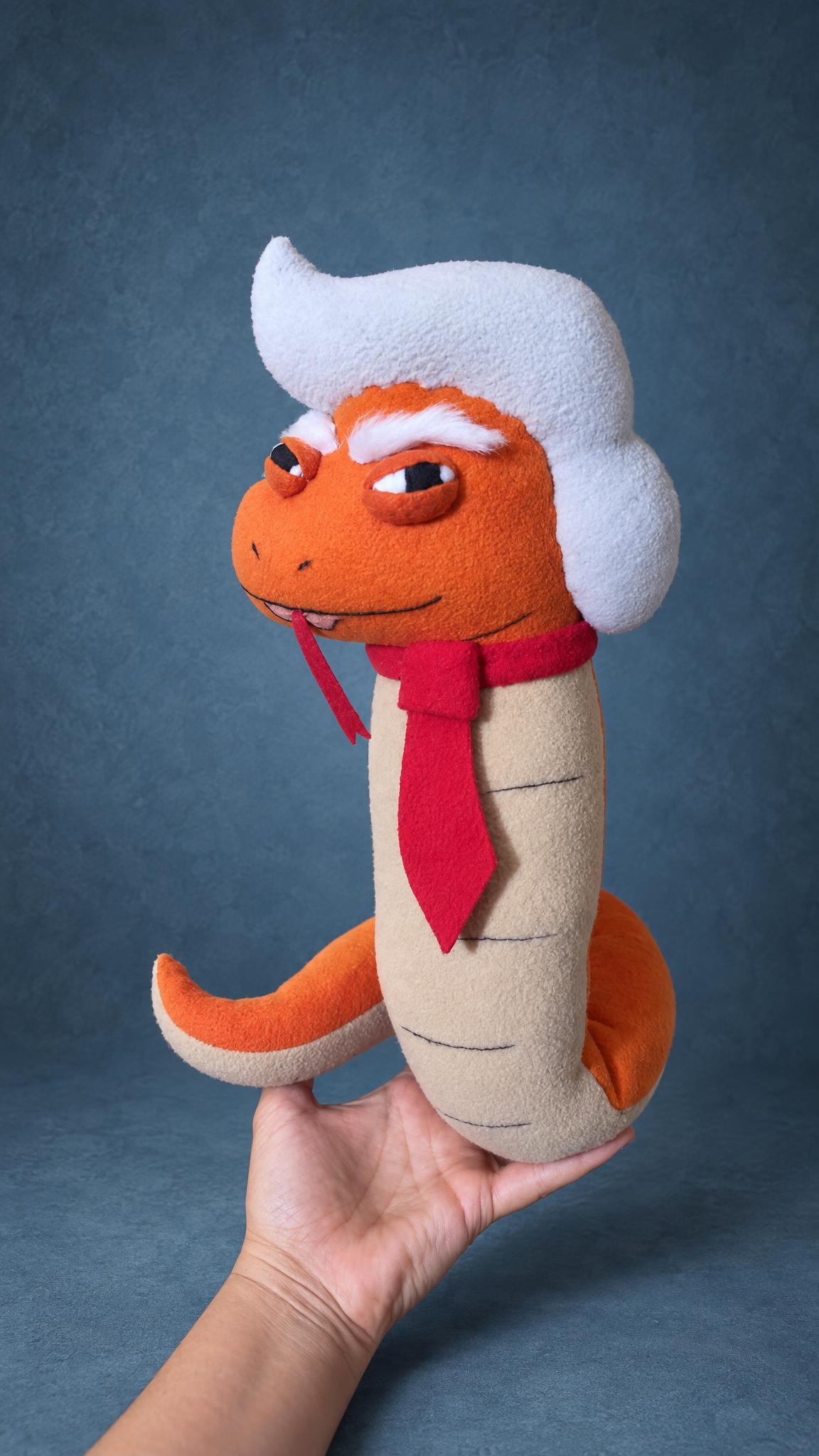 Trump parody snake plush with a red tie and forked tongue, sewn by hand to order from a sketch