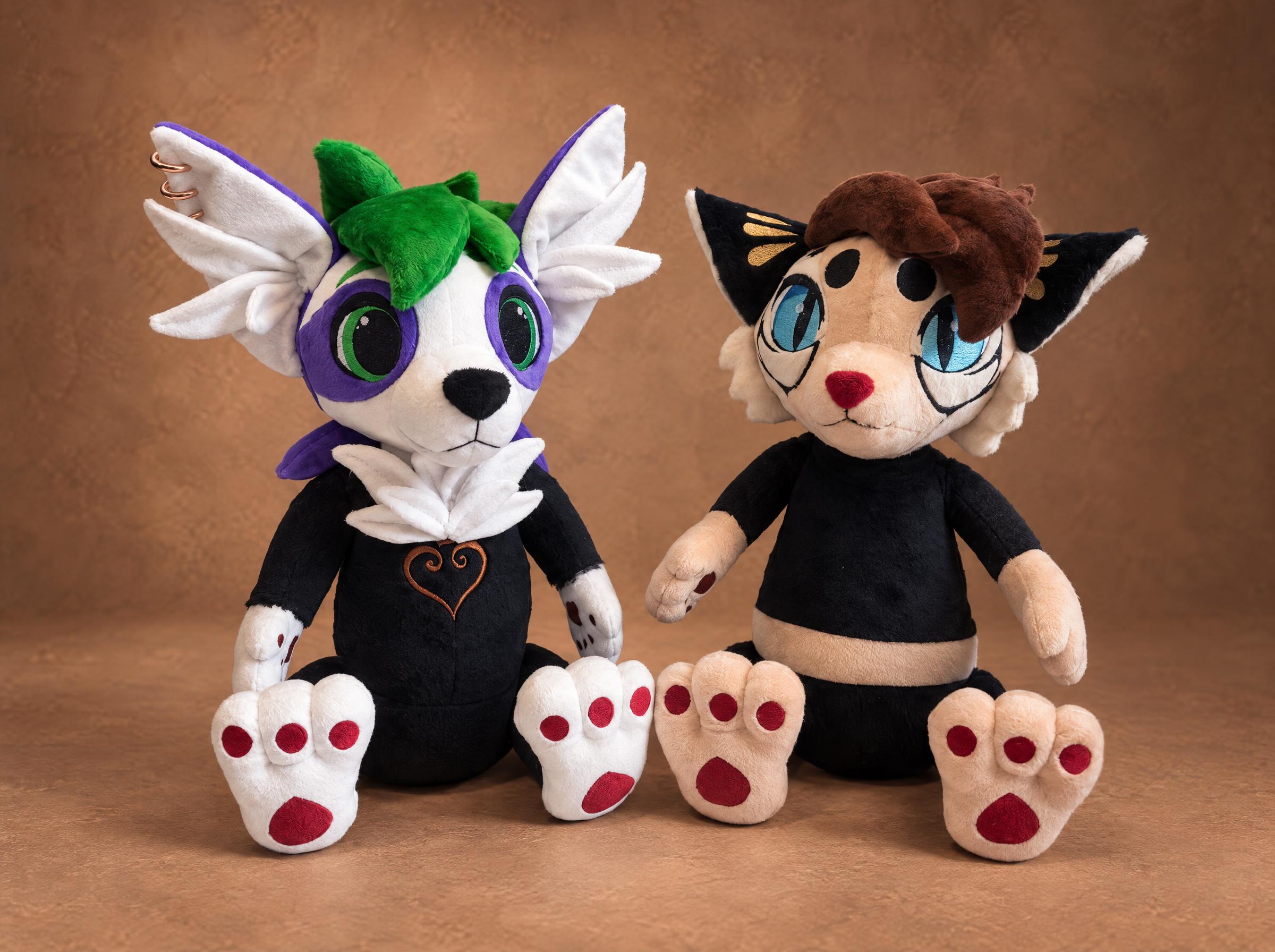 Two custom furry plushies made to order: a white OC with purple markings and a cream cat fursona