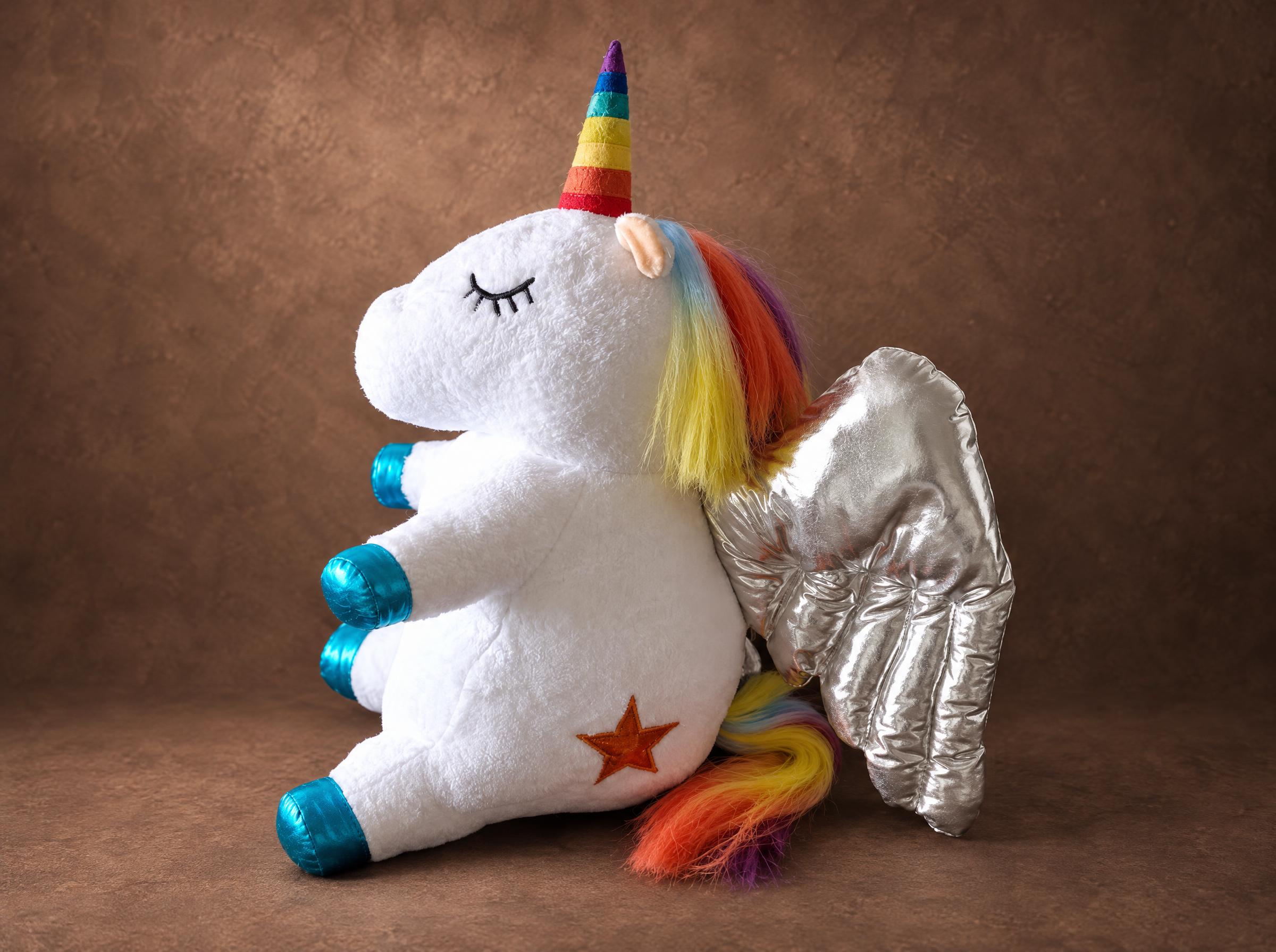 Unicorn plush with a rainbow mane and quilted silver wings, sewn by hand to order from a child's drawing