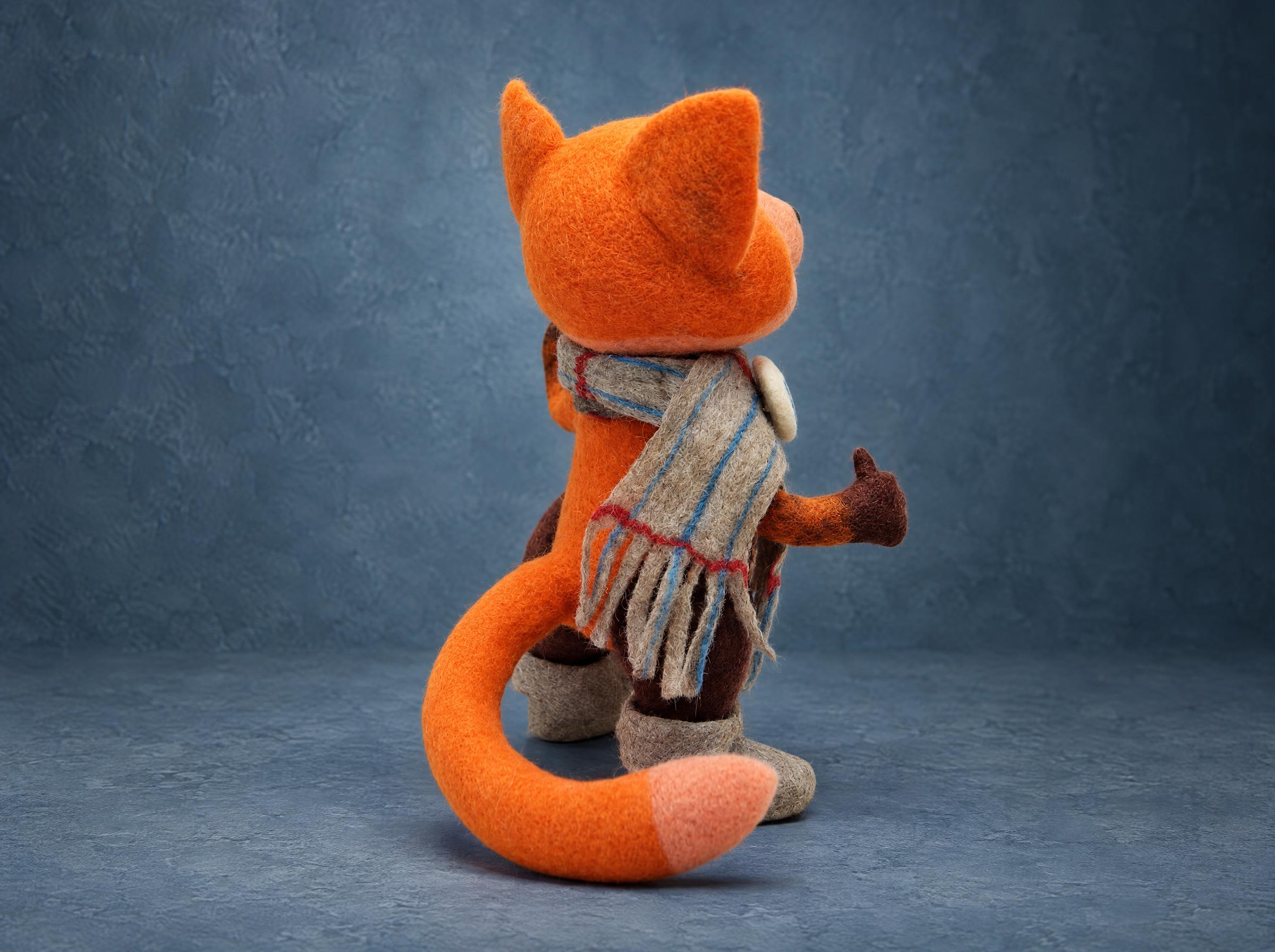Viber fox toy, tail and scarf from behind Back of the Viber fox toy: felted orange wool, a long poseable tail with a pale tip and a fringed grey scarf, made to order